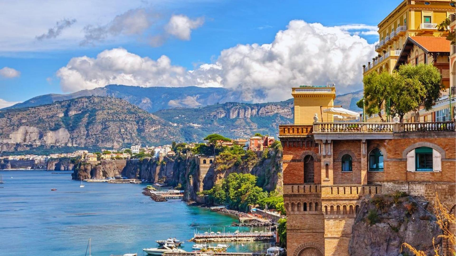 Scenic view of the Amalfi Coast in Italy, showcasing colorful cliffside villages and the sparkling Mediterranean Sea.