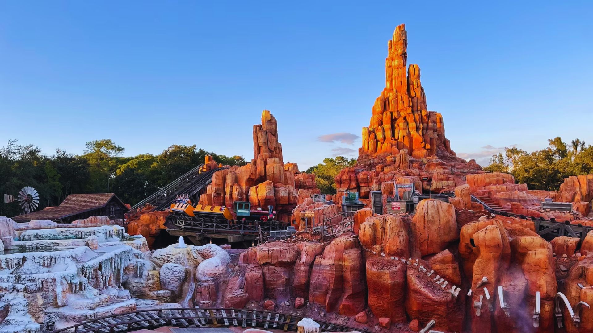 A view of Big Thunder Mountain, a beloved roller coaster attraction at Disney World, set in a vibrant, western-themed environment.