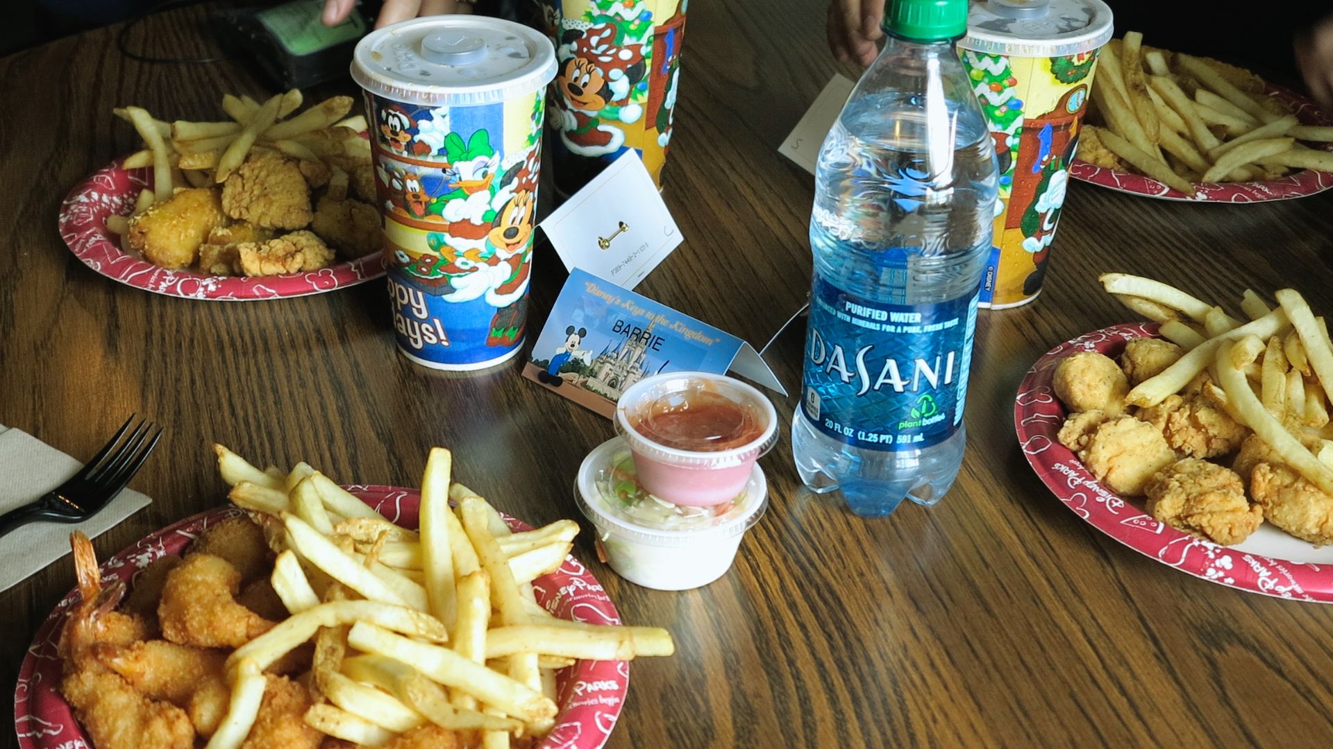 A table set with several plates and a bottle of water, ready for a meal.