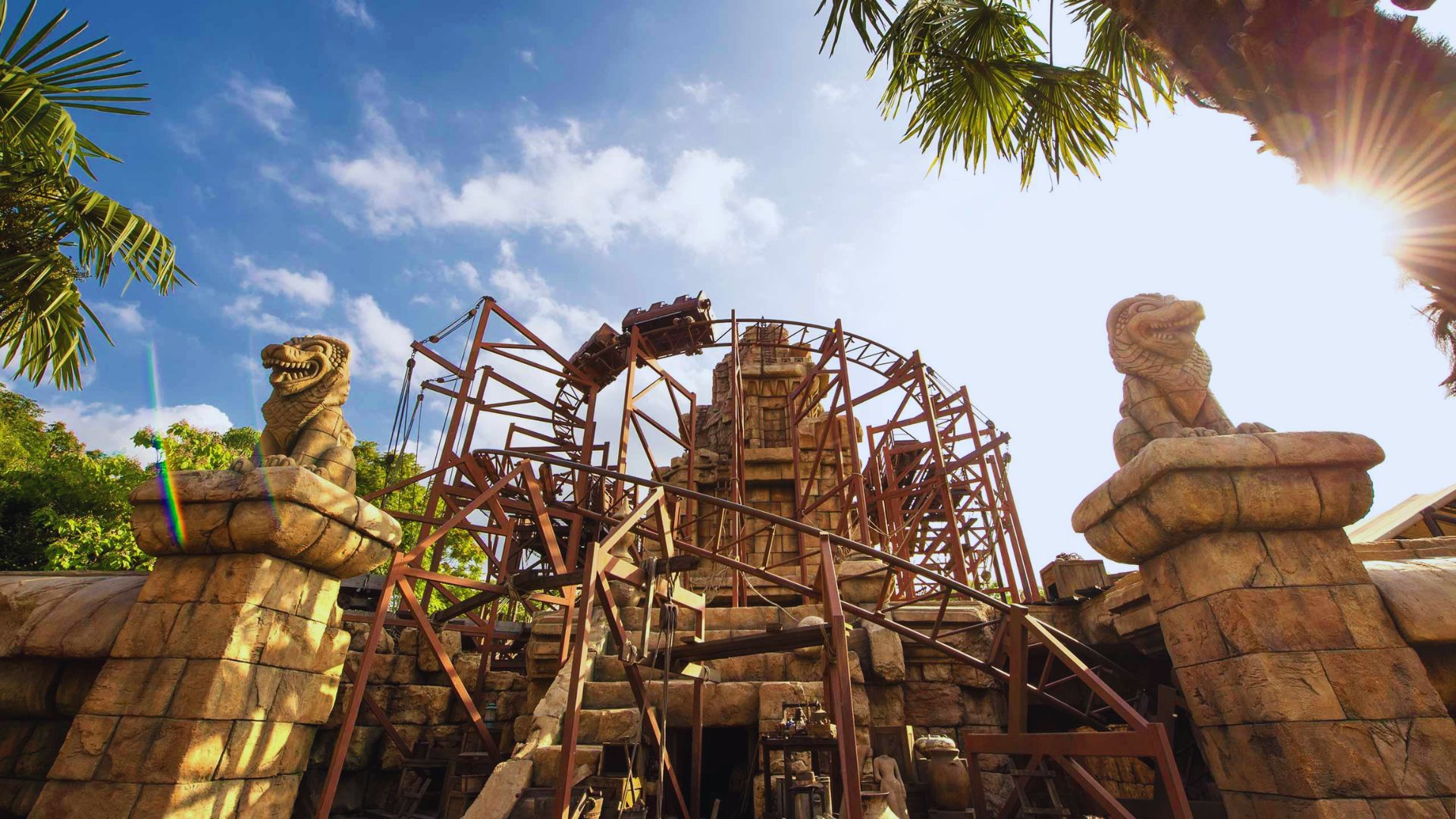 A large structure illuminated by bright sunlight, casting distinct shadows on the ground.