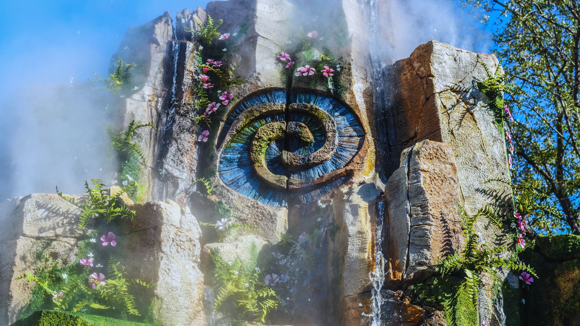Water fountain at Universal Studios Hollywood, featuring a vibrant design and surrounded by lush landscaping.