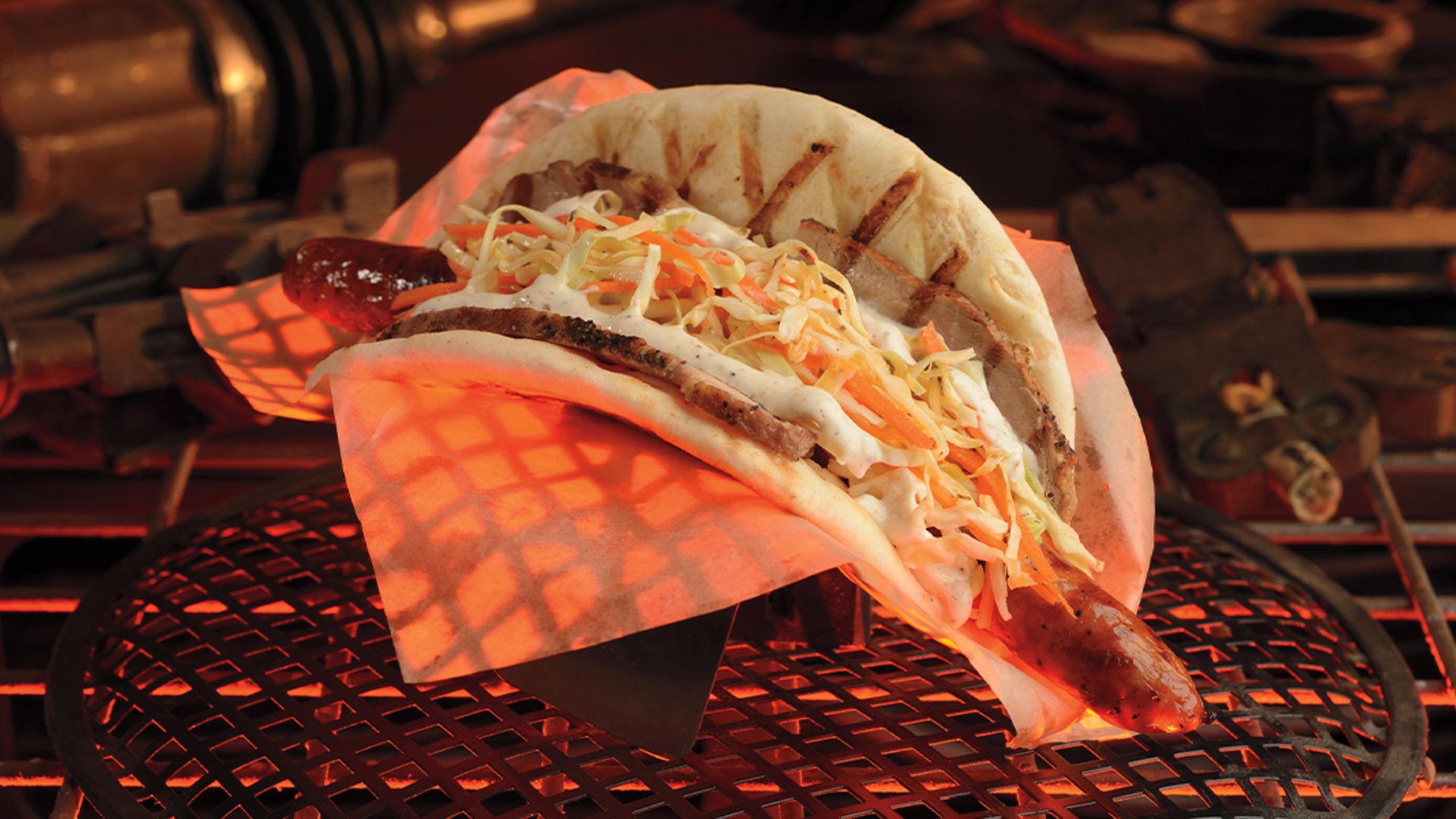 A hot dog in a bun topped with coleslaw and melted cheese, served on a white plate.