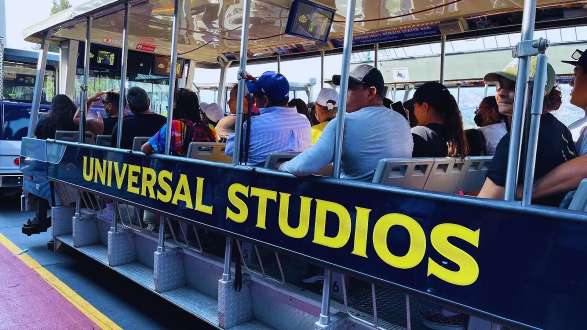 Universal Studios Hong Kong entrance featuring iconic attractions and vibrant signage under a clear blue sky.
