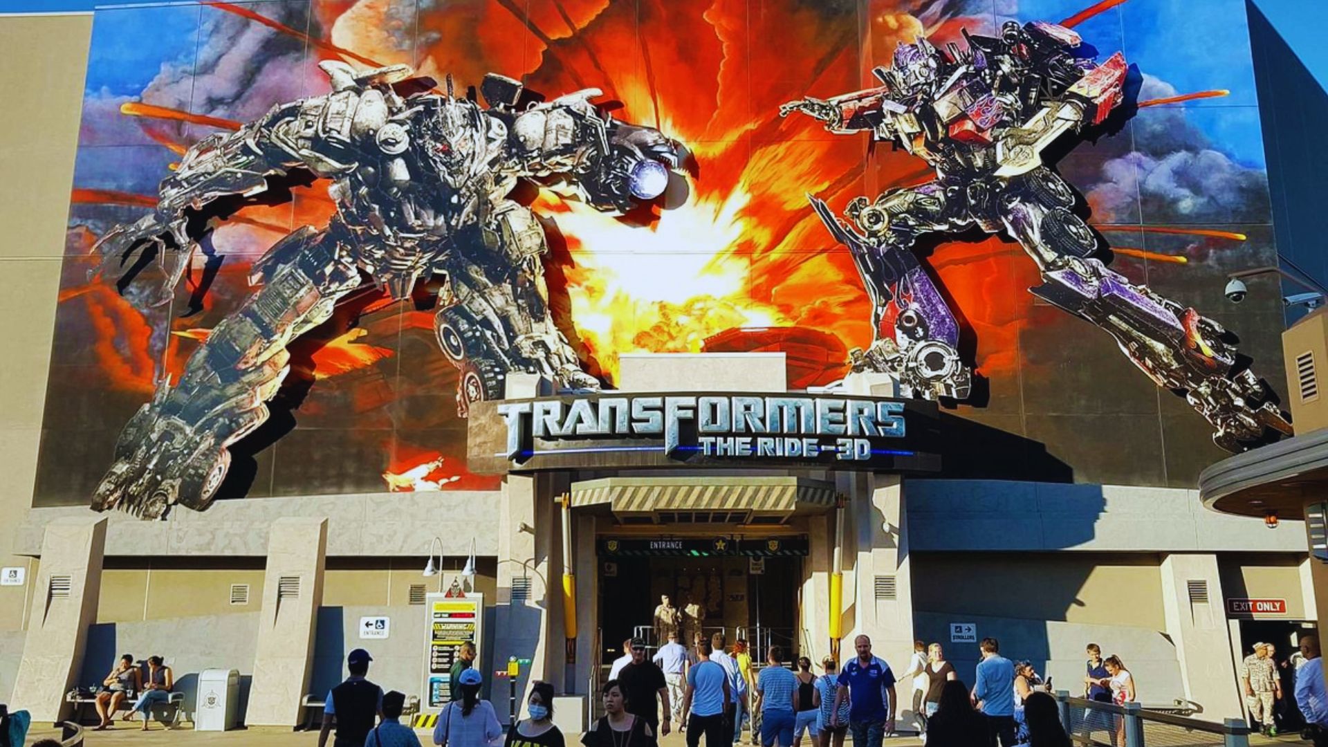 A large billboard featuring a giant image of Transformers characters in an action-packed scene.
