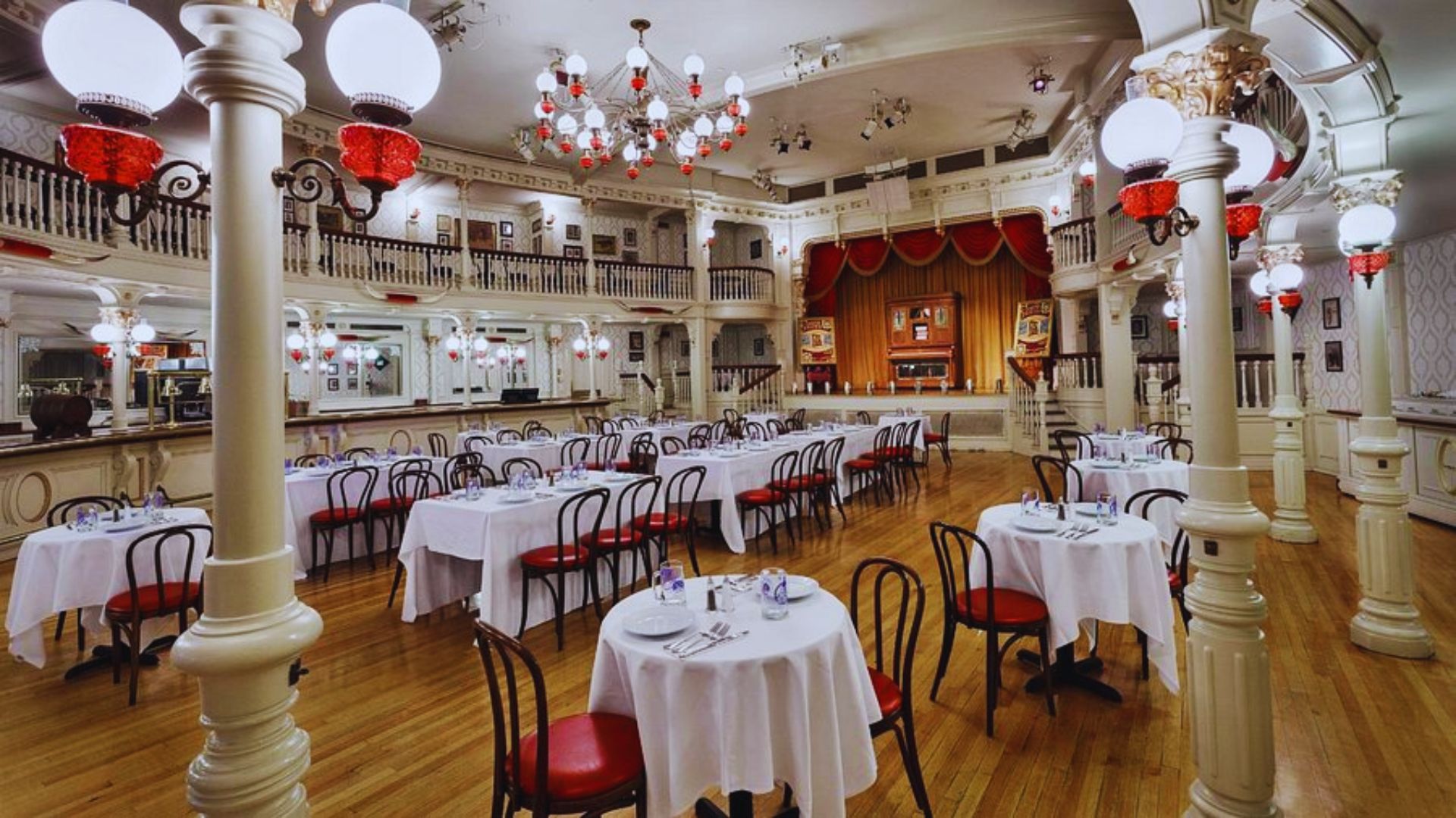 Elegant dining room at the grand hotel, featuring ornate decor, a large chandelier, and beautifully set tables.