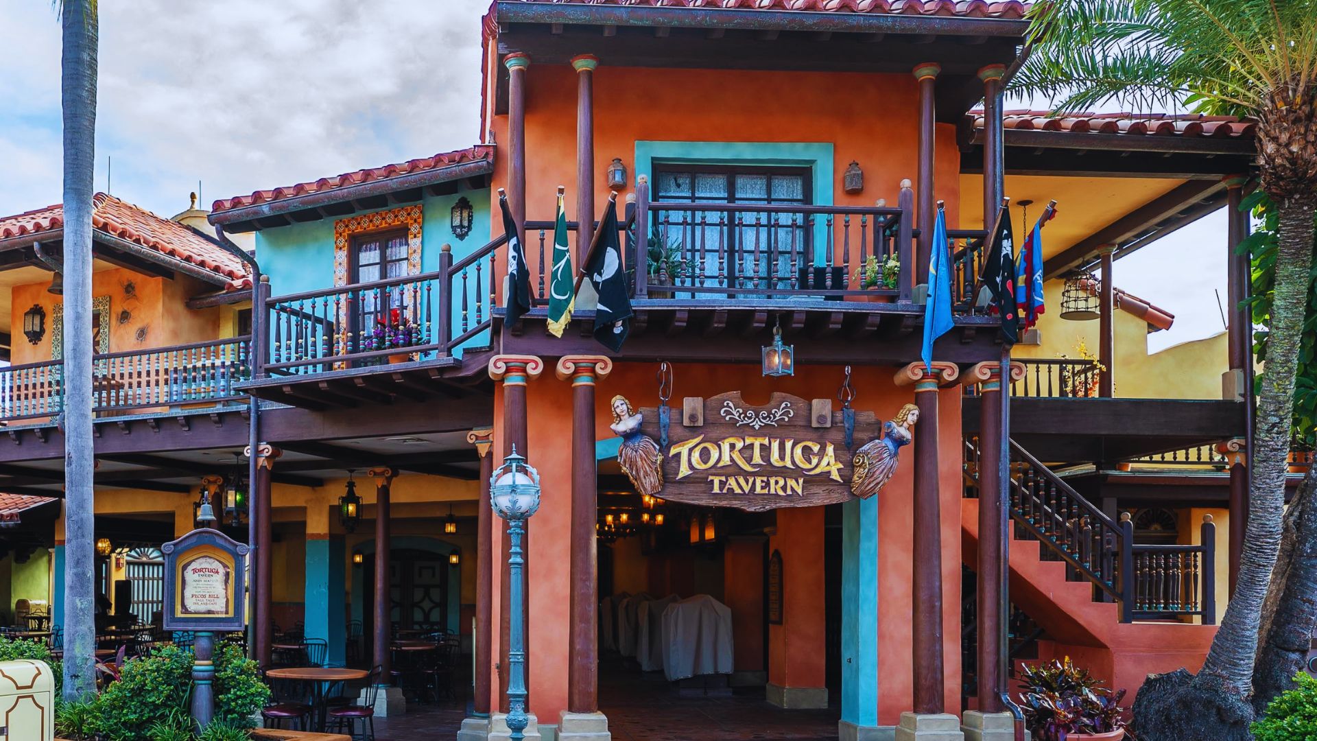 A vibrant restaurant facade featuring a mix of bright colors and decorative elements, inviting customers inside.