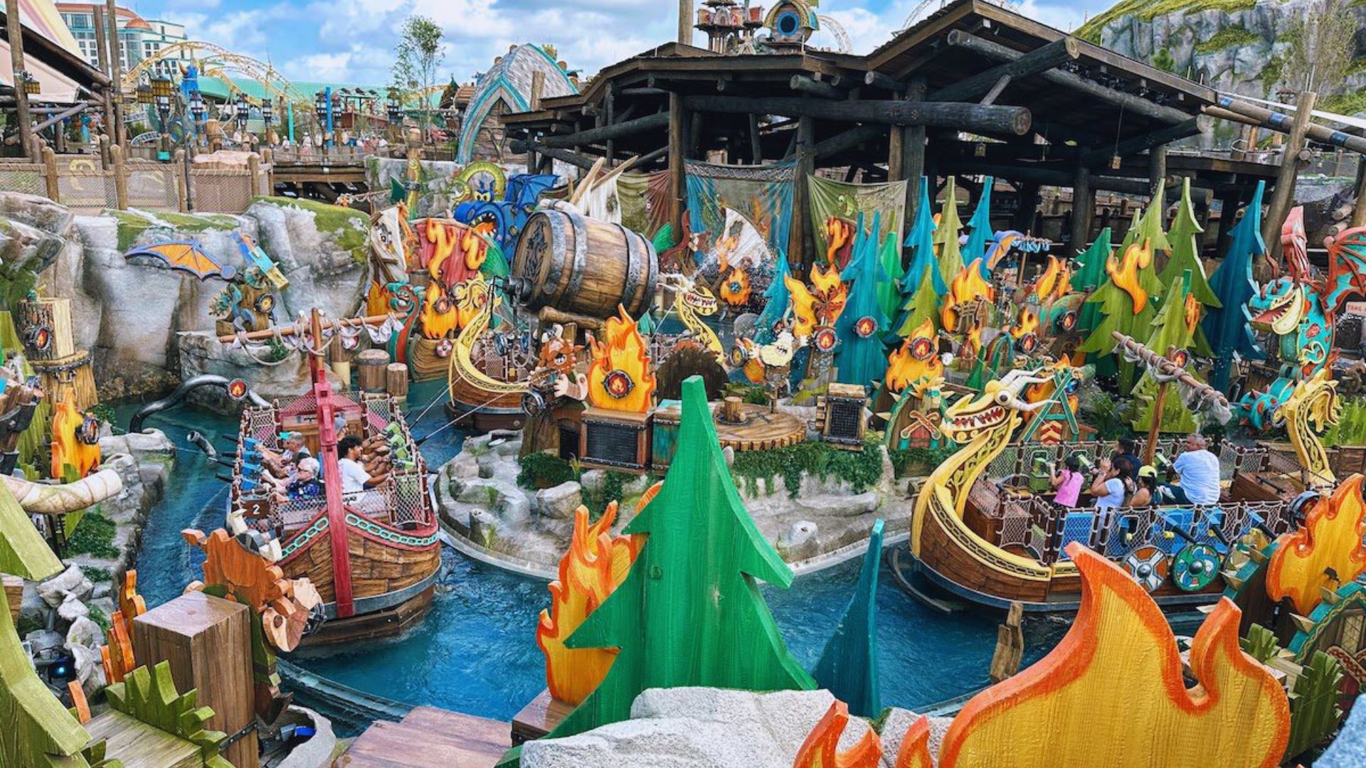 A bustling water park filled with numerous boats and people enjoying various water activities under a clear blue sky.