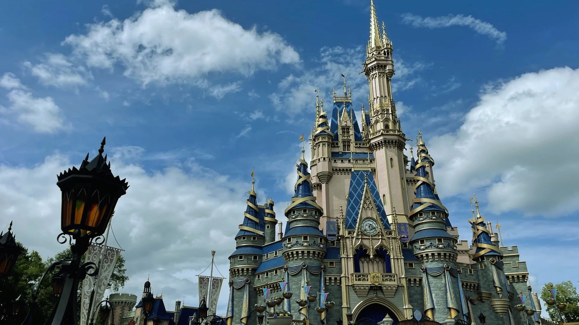 Cinderella Castle stands majestically in the background, showcasing its iconic spires and enchanting architecture.