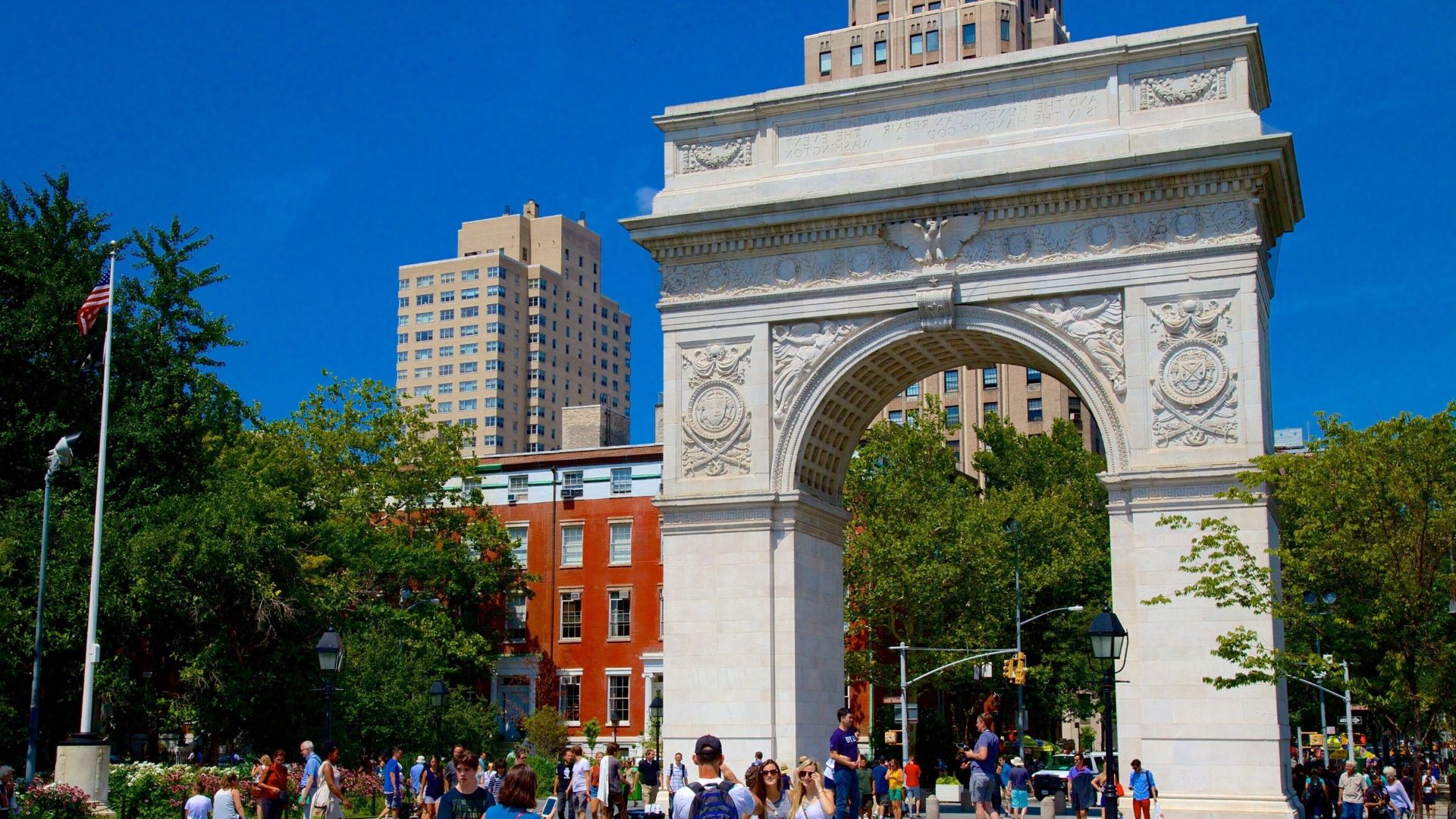 . A large arch with people walking around it, showcasing a lively atmosphere and architectural grandeur.