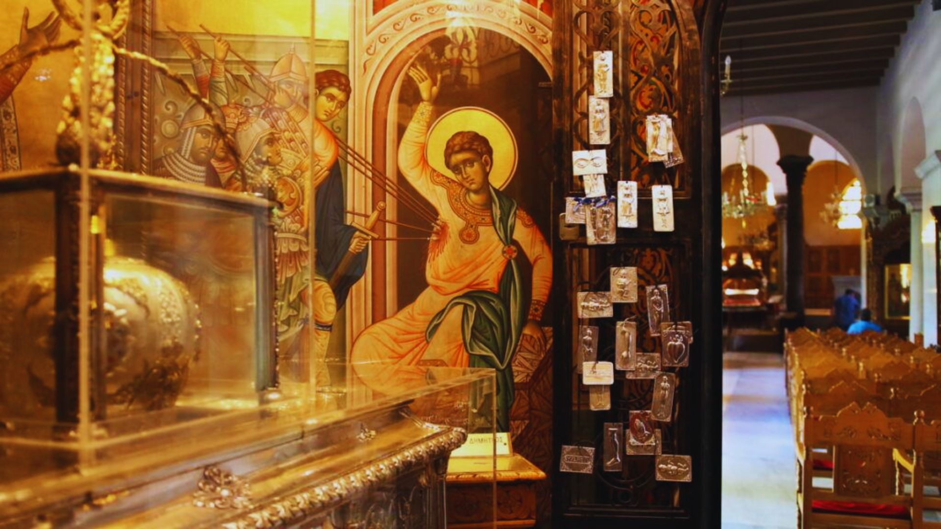 Inside view of a church showcasing a gold altar surrounded by beautiful paintings.