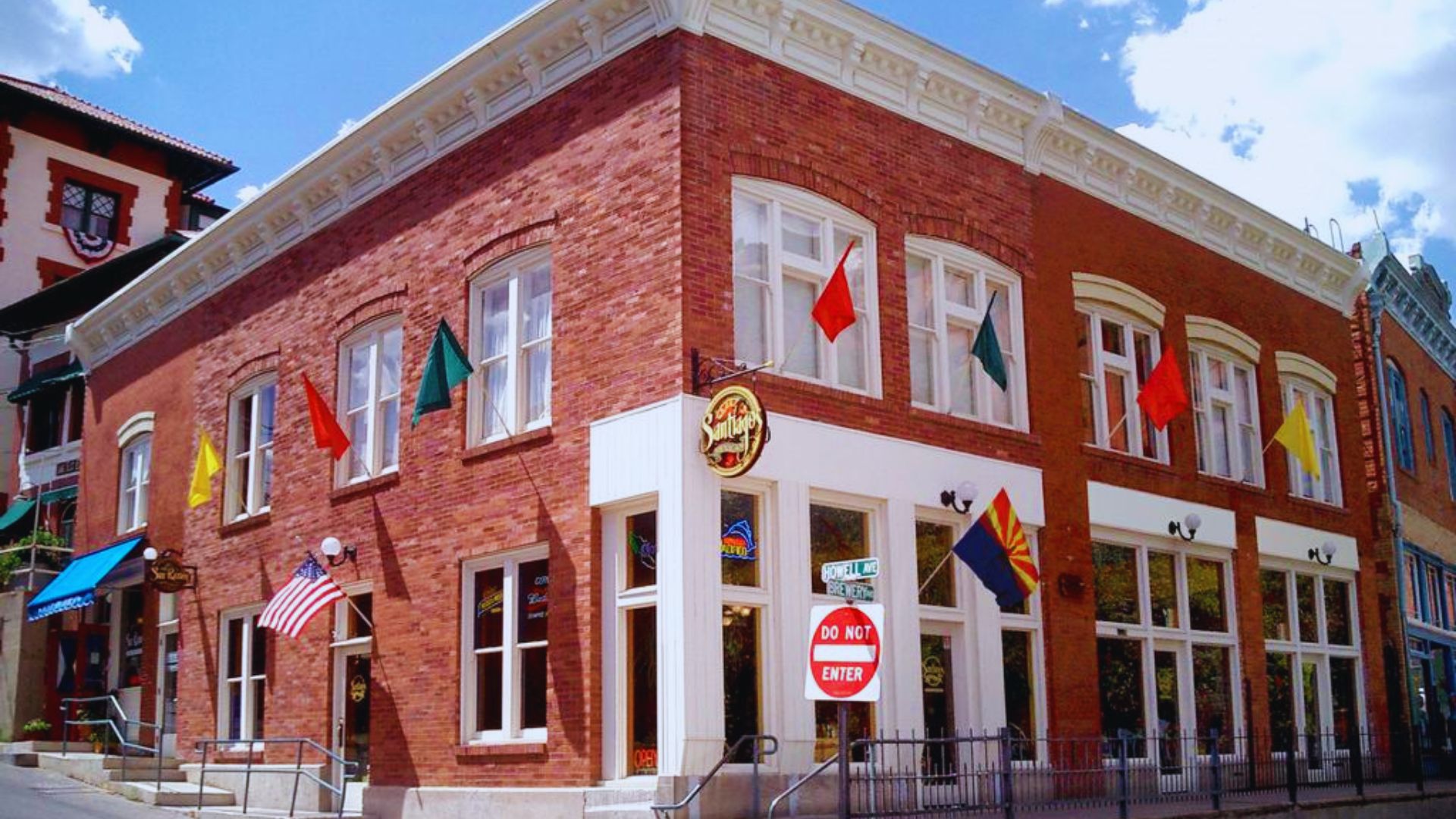 A red brick building featuring a sign that reads "the hotel" prominently displayed on its facade.
