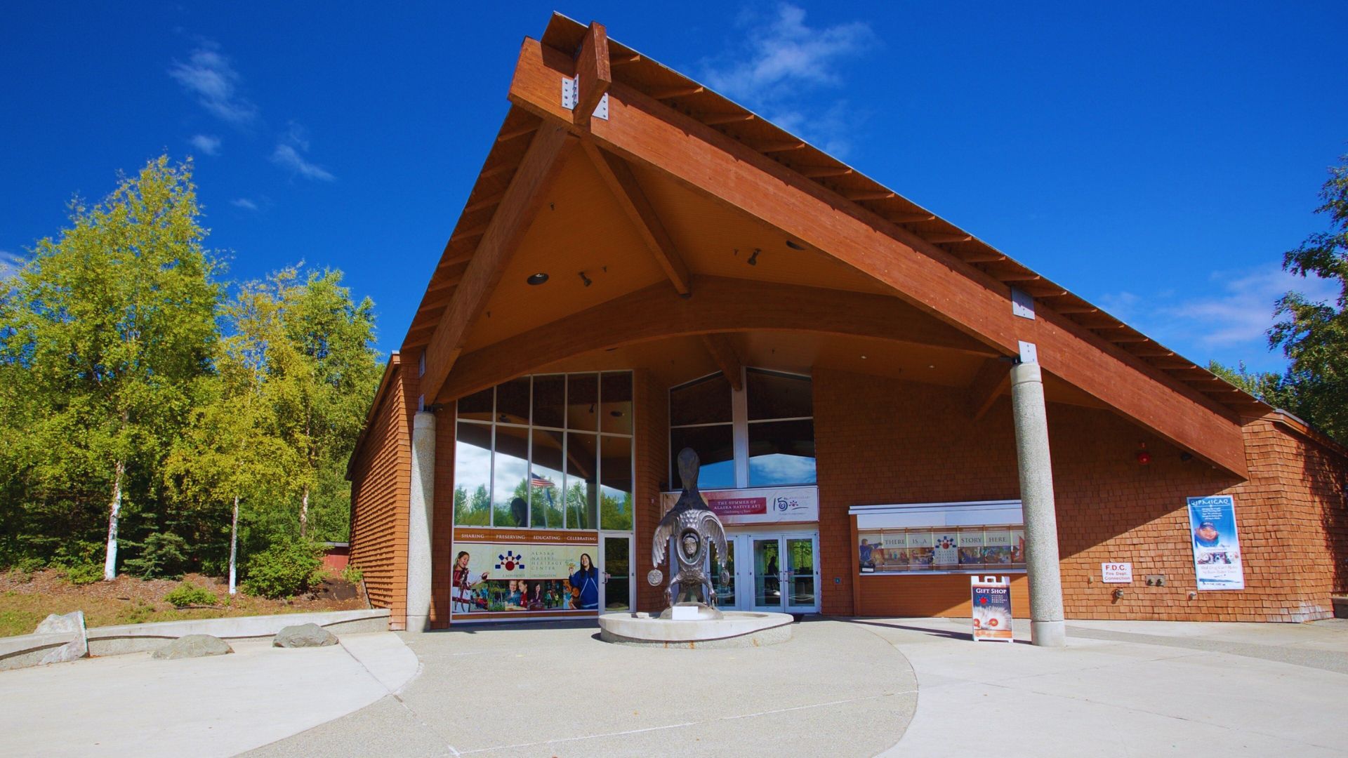 A large building featuring an expansive roof, showcasing its impressive architectural design.