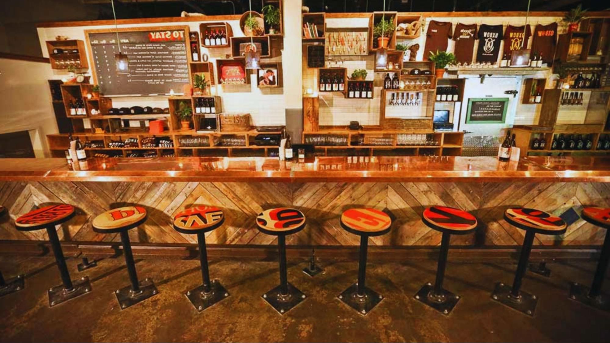 A view of The New Yorker's bar, showcasing its chic design and guests socializing over cocktails in a refined setting.