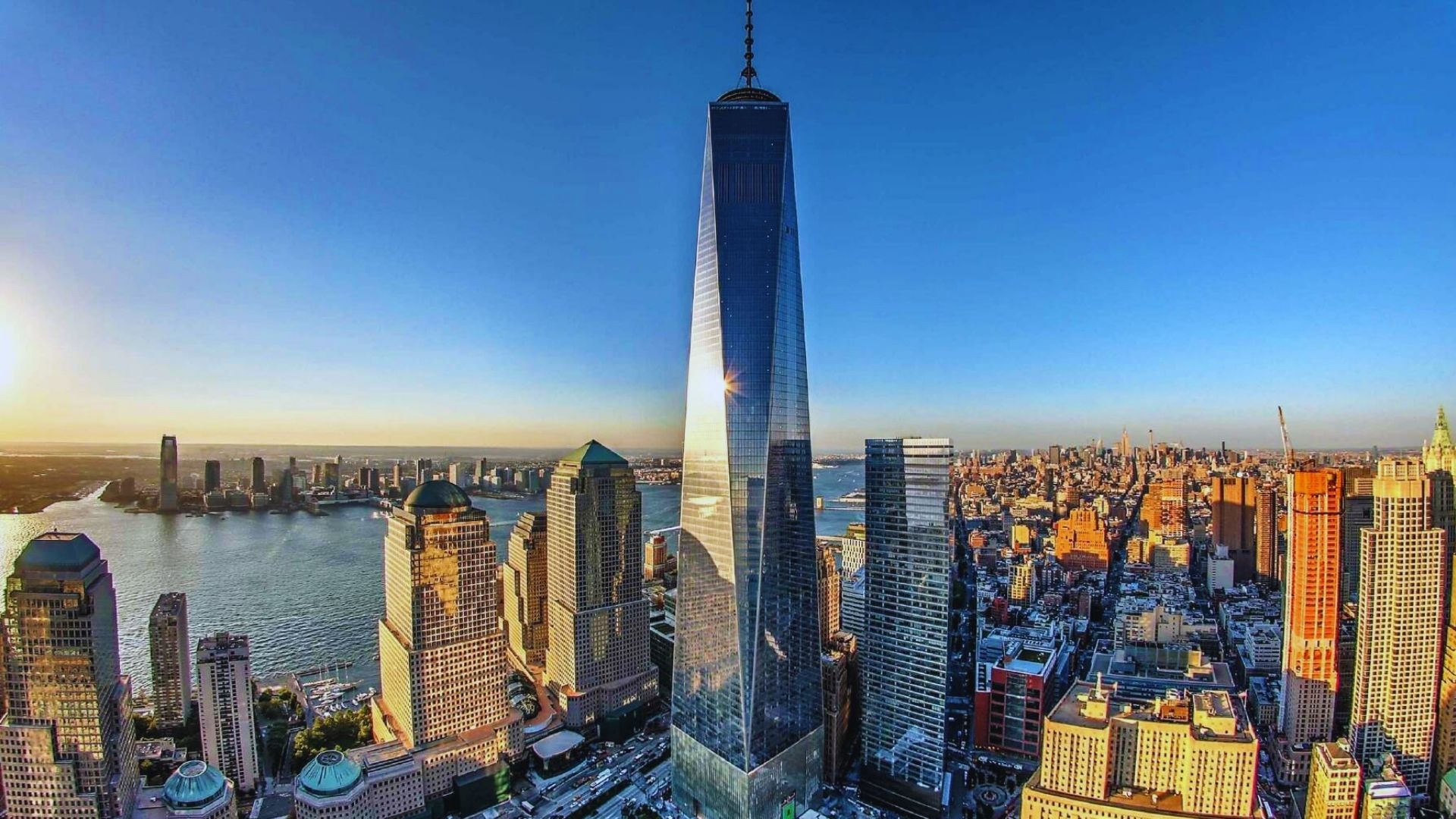Overhead perspective of One World Trade Center, highlighting its height and architectural design against the city backdrop.