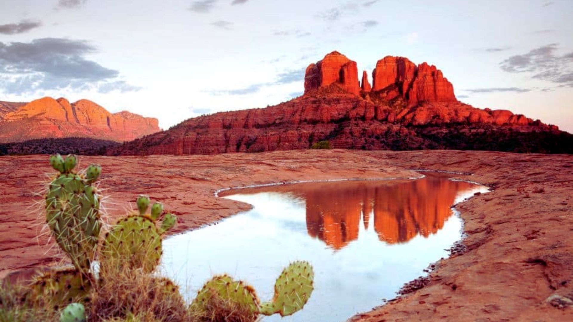 Image of Cathedral Rock's reflection in water, taken by Jimmy Kirk, highlighting the beauty of the landscape at sunset.