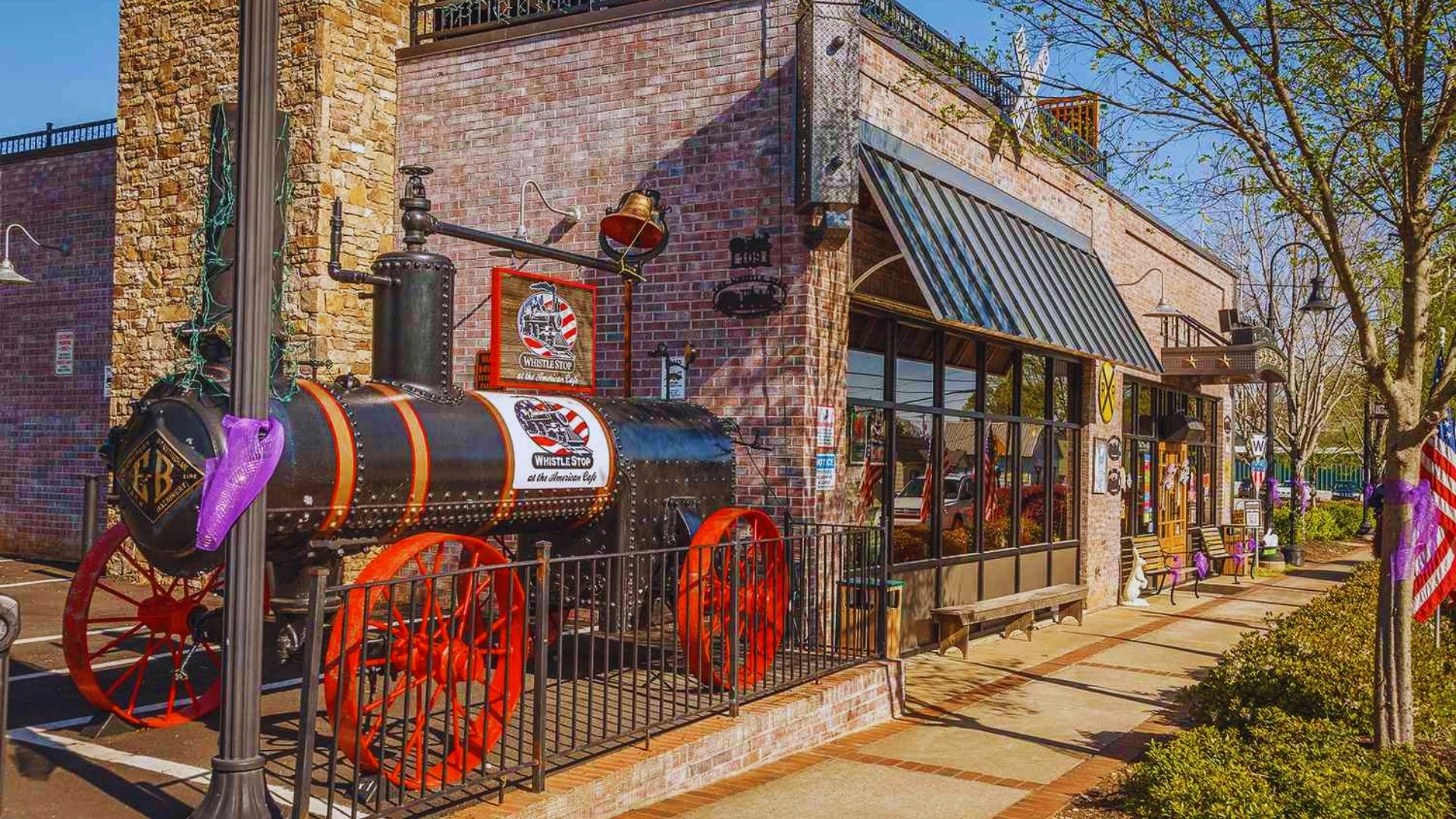 A brick building featuring a vintage steam engine mounted on its side, showcasing industrial heritage and architecture.