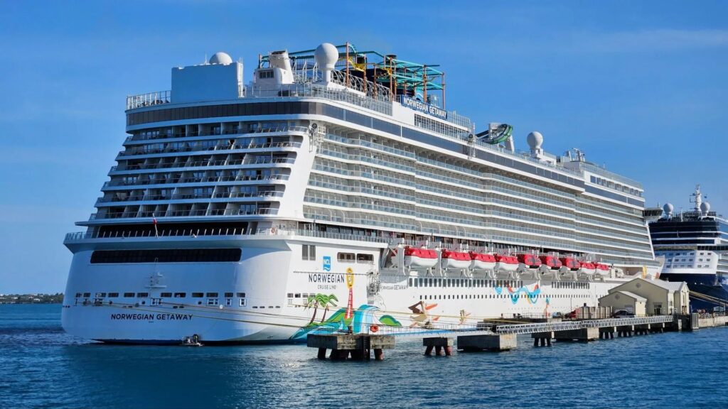 Norwegian Getaway Reviews: Real Traveler Experiences Norwegian Breakaway cruise ship docked, showcasing its vibrant exterior and modern design against a clear blue sky.