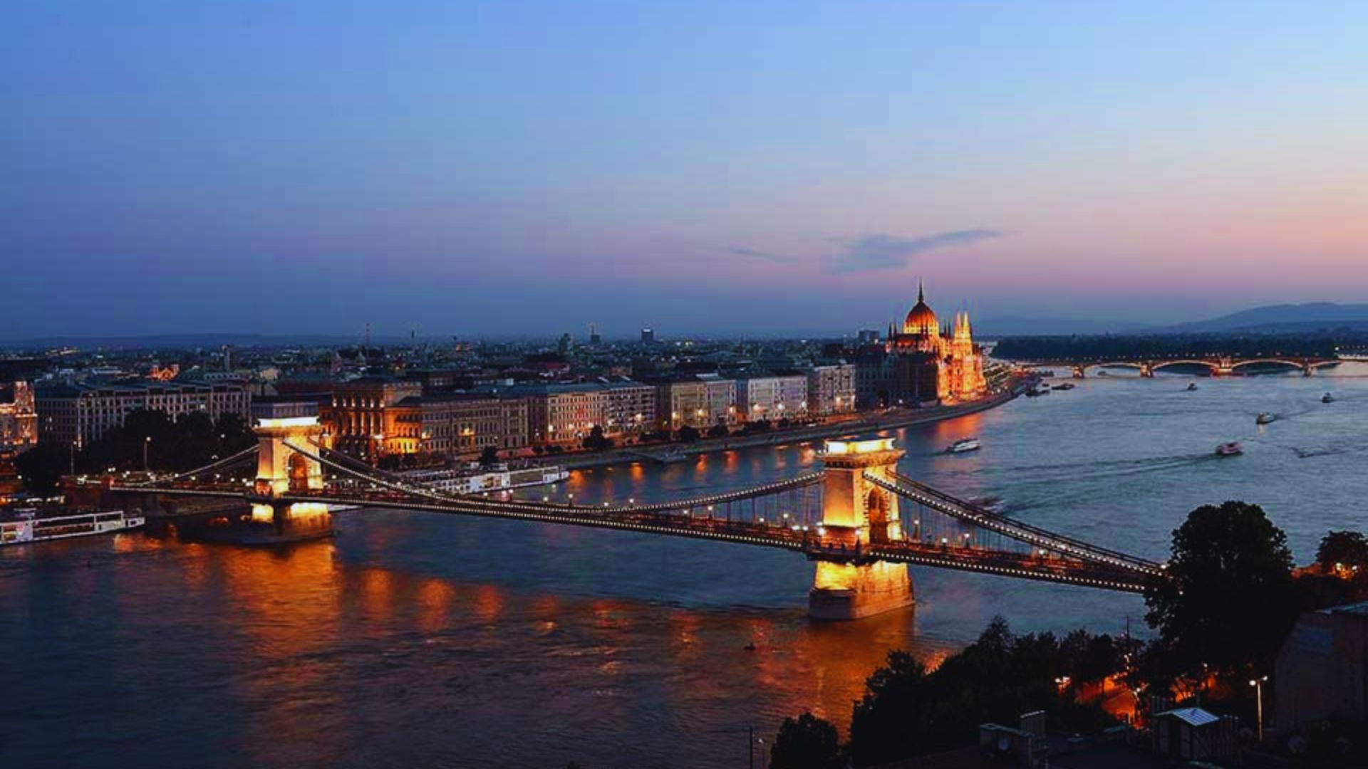 Chain Bridge in Budapest, Hungary, spanning the Danube River with historic architecture and cityscape in the background.