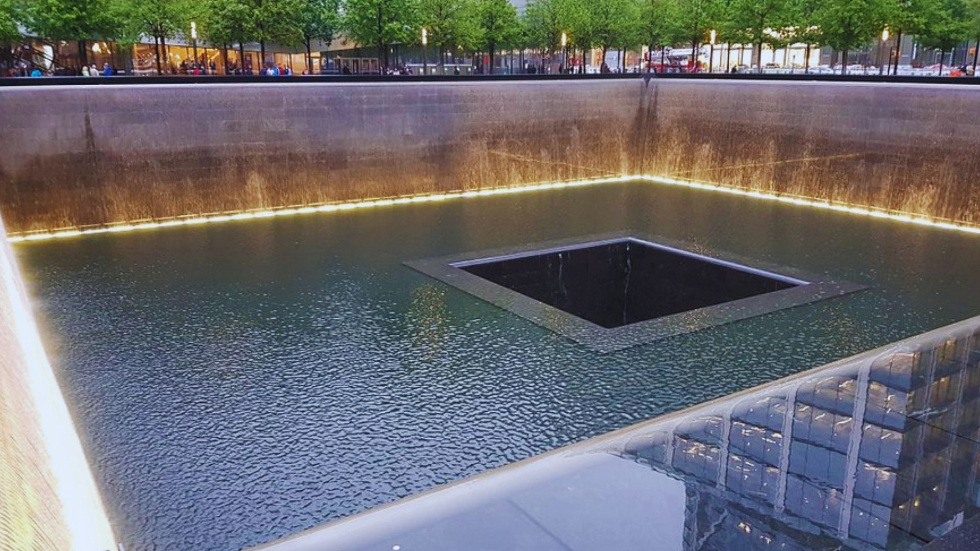 The tranquil reflection of water in the 9/11 memorial, symbolizing remembrance and peace for those lost.
