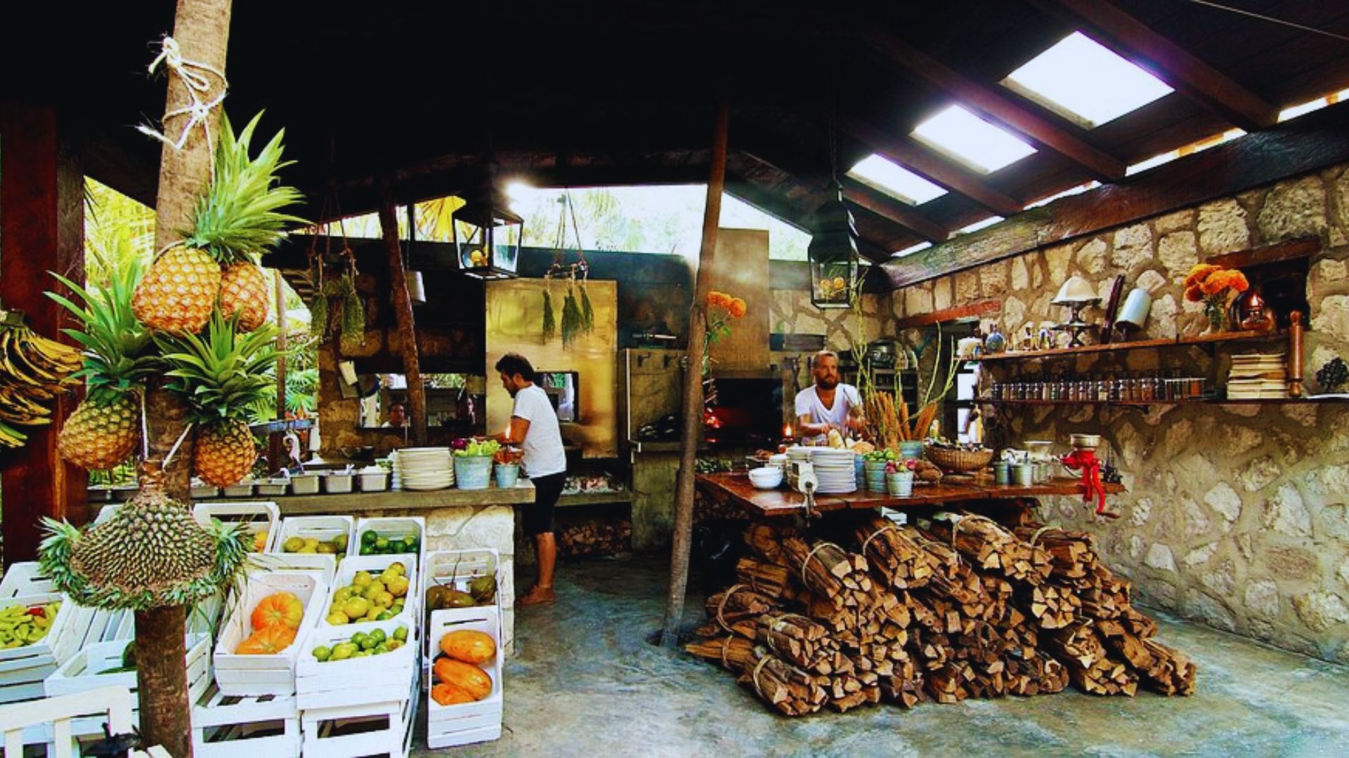 A small store displaying a colorful assortment of fresh fruits and vegetables on shelves and tables.