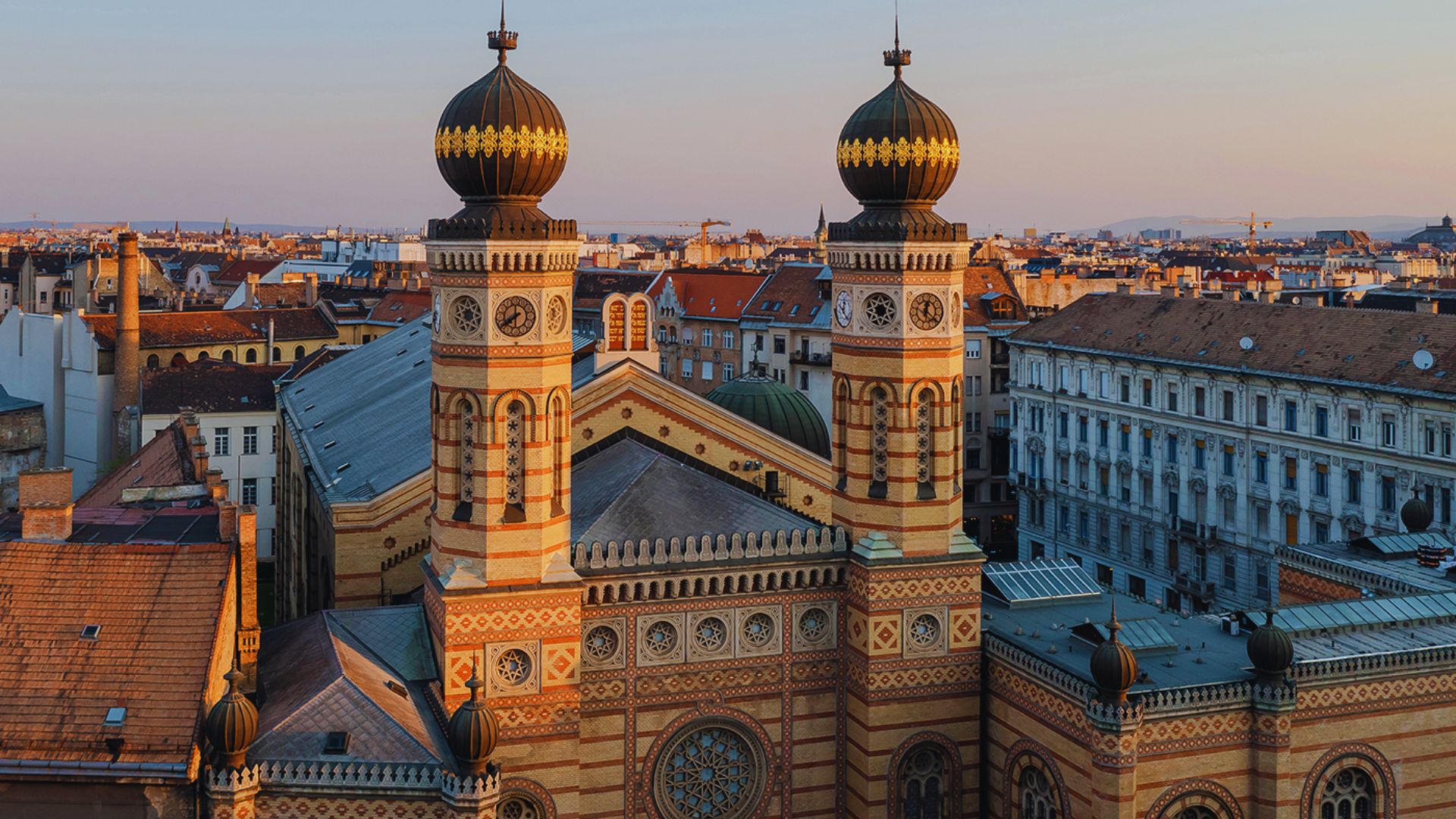 Overhead perspective of a vibrant city, showcasing a dense arrangement of buildings and urban infrastructure.
