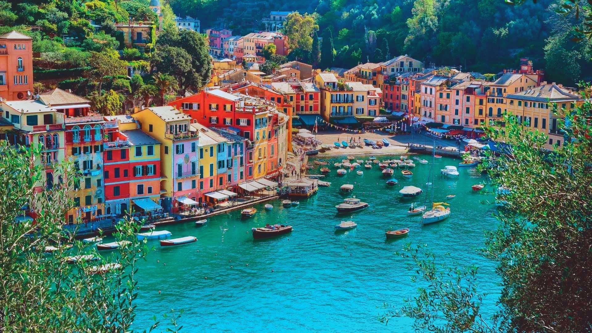 Vibrant houses lining the water's edge in Italy, showcasing a picturesque coastal scene.