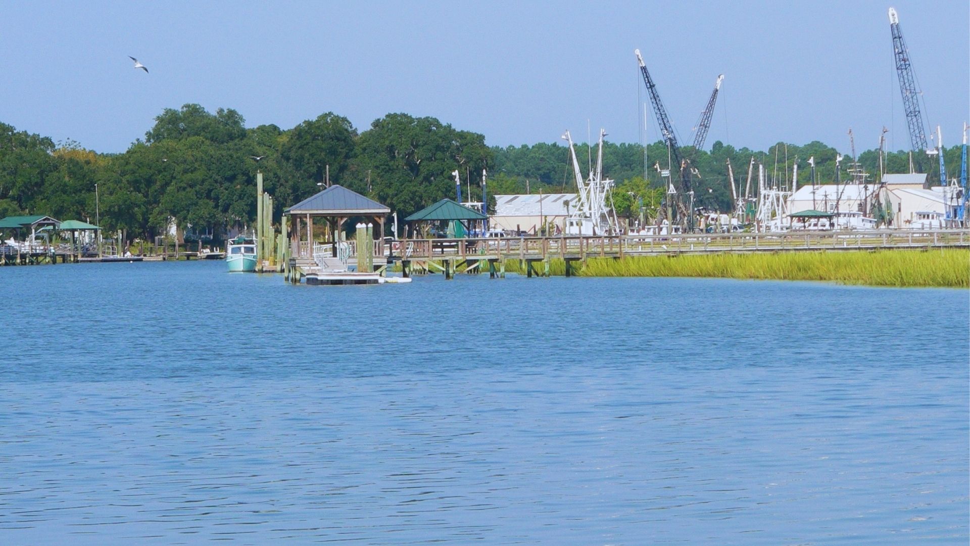 A picturesque waterfront view showcasing a dock and a boat resting on the calm water.