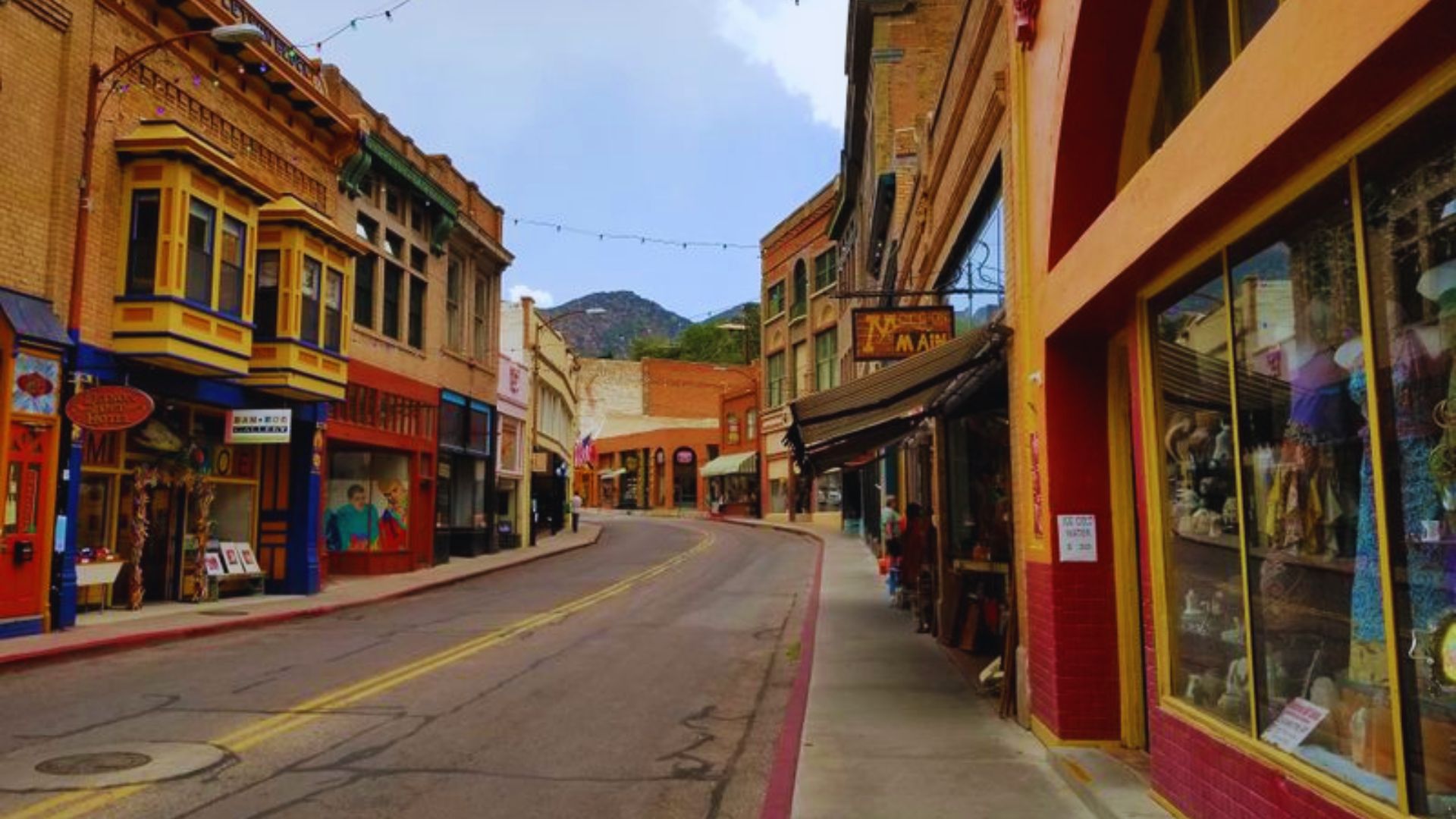A lively street scene featuring shops and buildings, representing the heart of the town's commercial area.