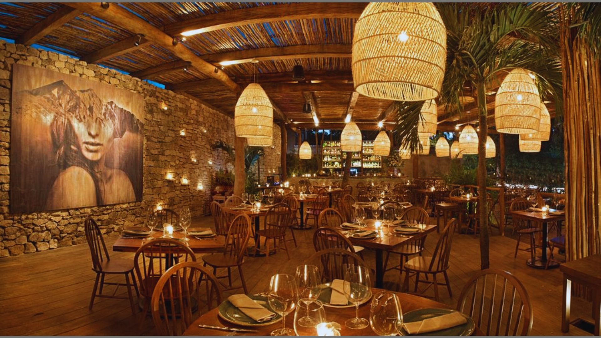 Interior of a restaurant showcasing rustic wooden tables and chairs for guests.