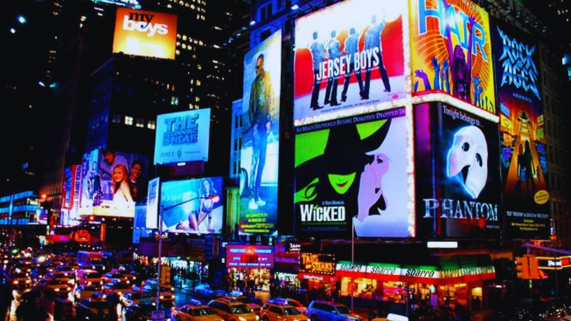 A bustling Times Square in New York City, filled with bright billboards and crowds of people.