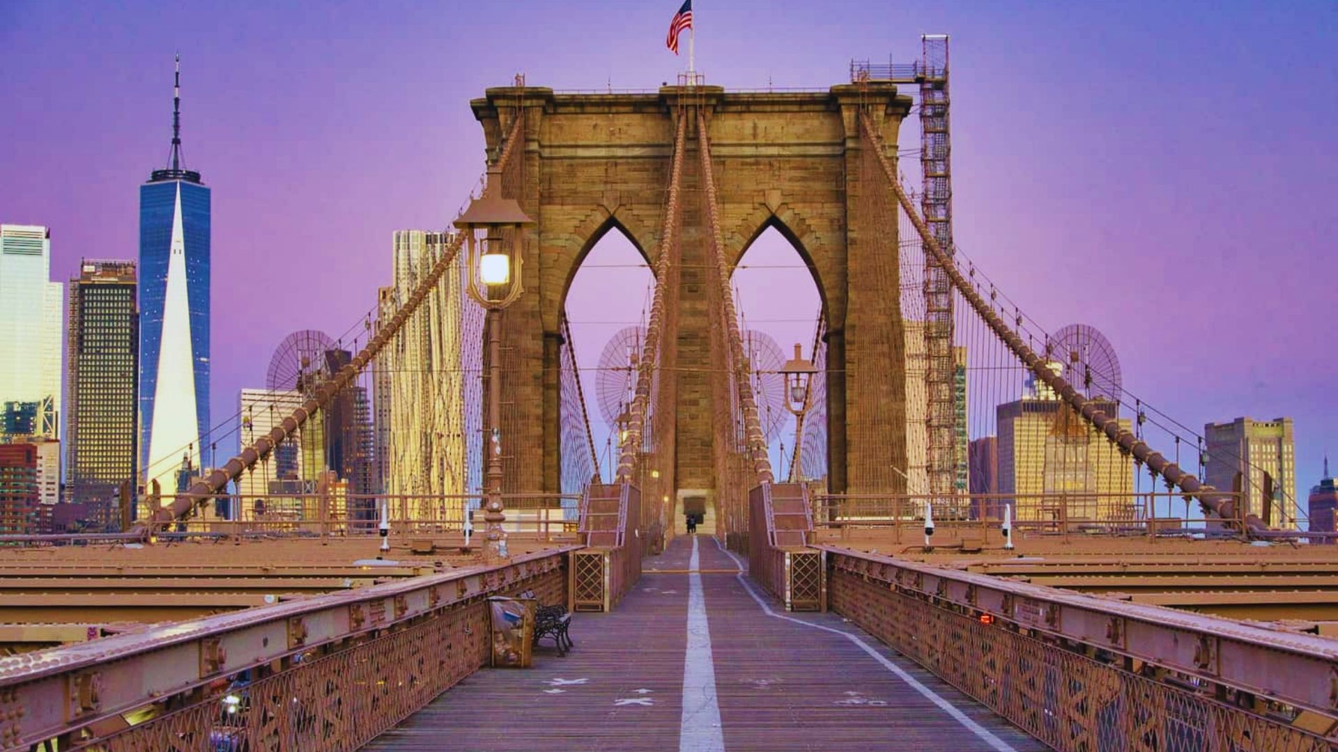 3. A stunning view of the Brooklyn Bridge during sunset, showcasing a dramatic sky filled with warm colors and the bridge's silhouette.