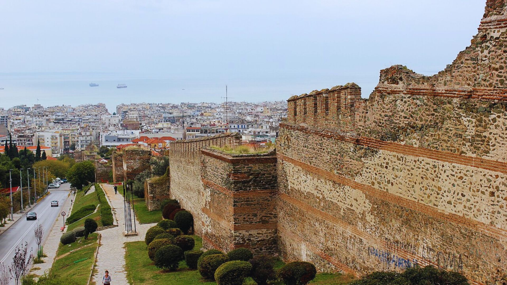 A panoramic view of the city skyline from the top of the ancient wall, showcasing buildings and greenery below.