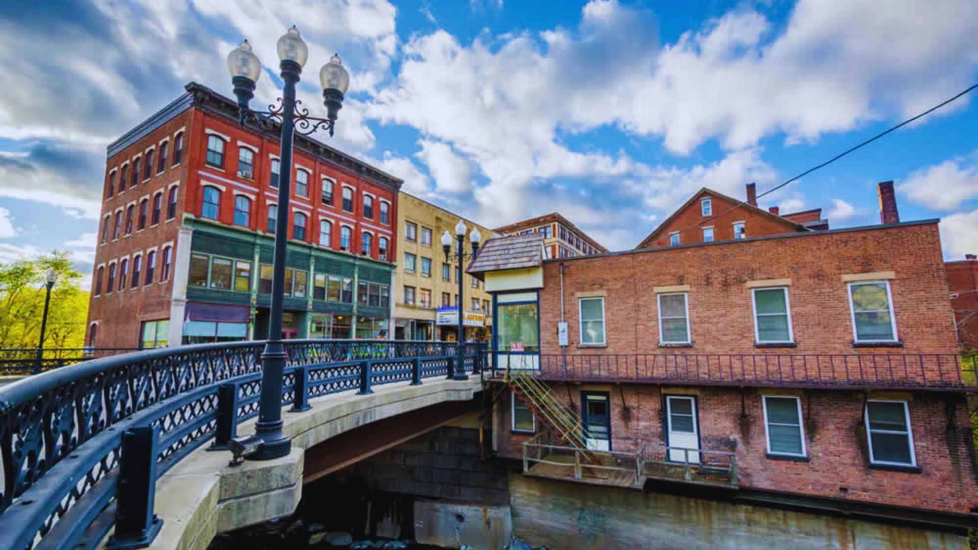 A bridge crosses a river in an urban setting, highlighting the city's landscape and waterway.