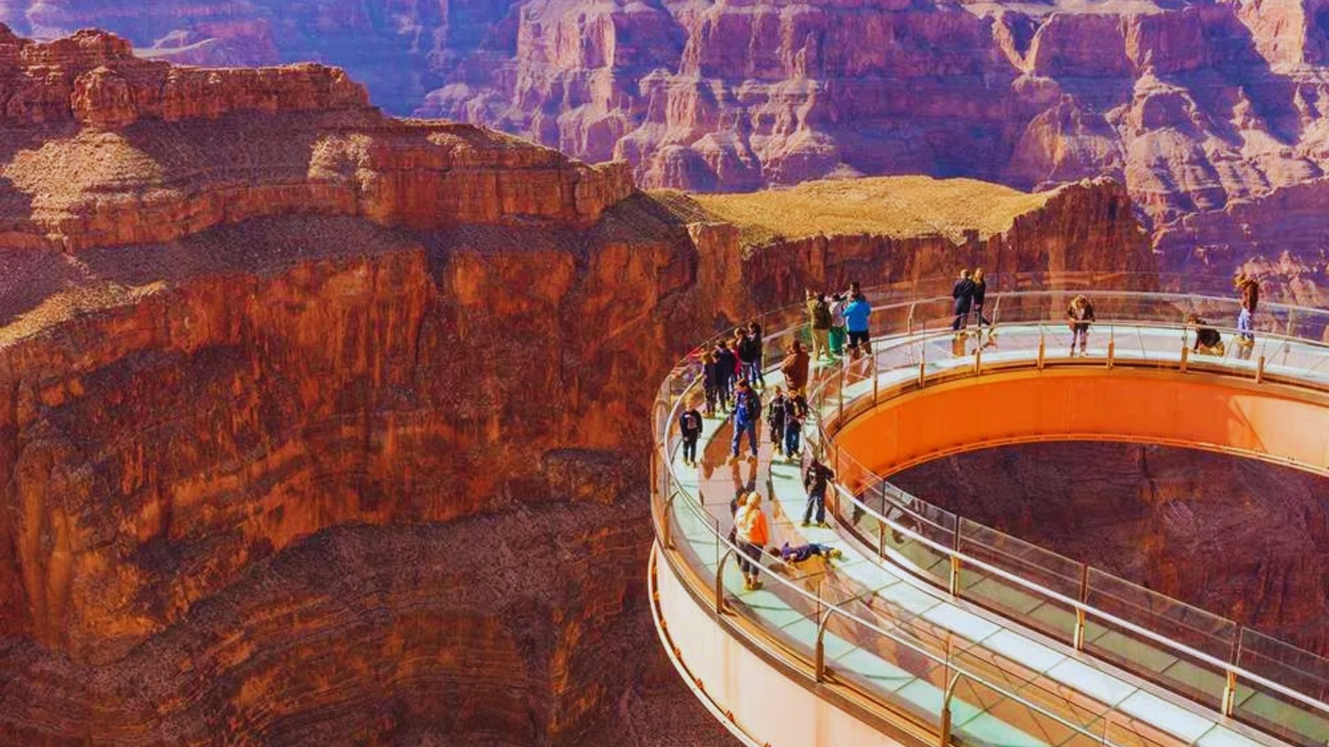 A panoramic view of the Grand Canyon National Park in Arizona, showcasing its vast cliffs and colorful rock formations.