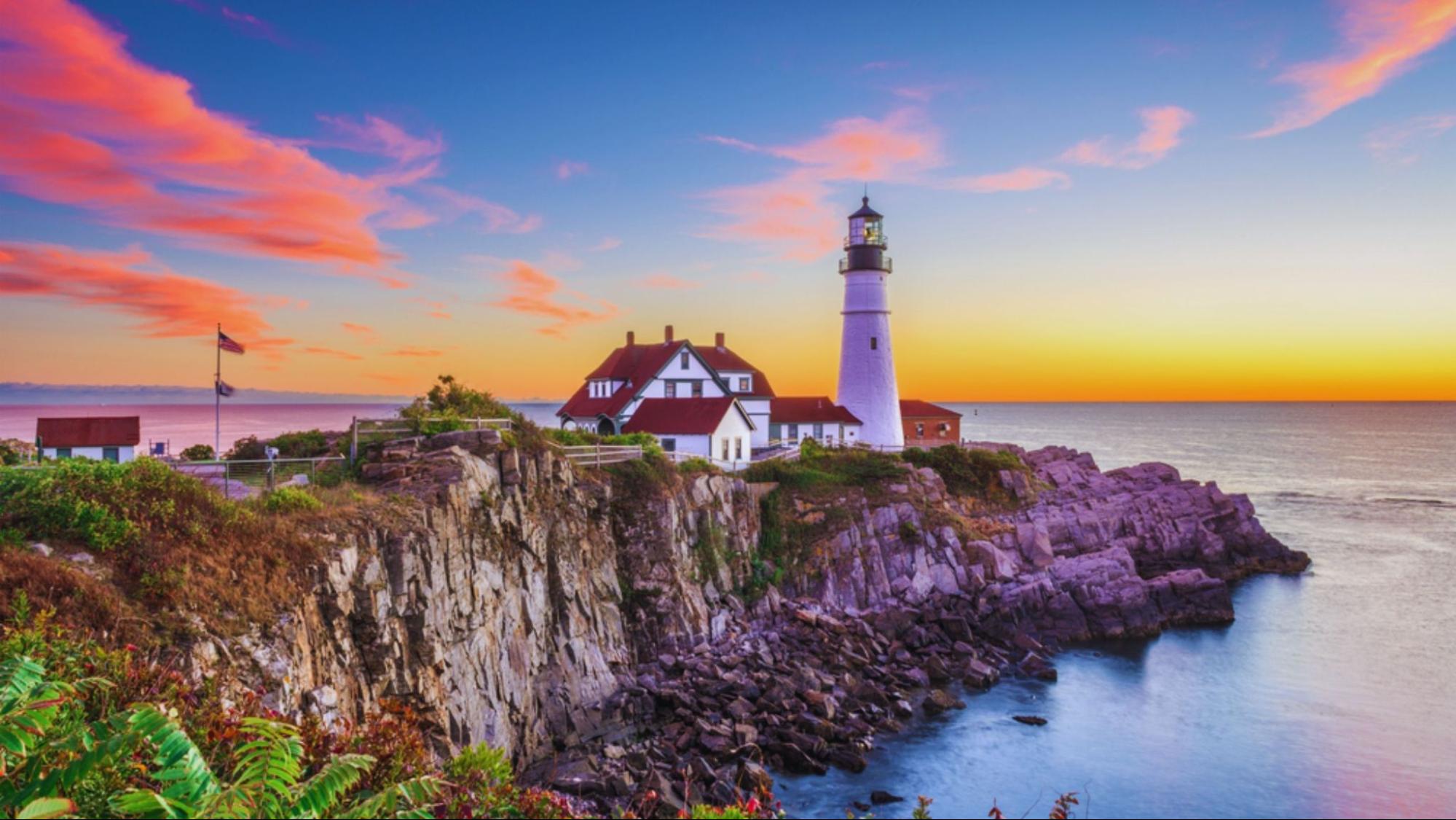 Portland Head Light lighthouse standing tall against a clear blue sky in Cape Elizabeth, Maine, USA.