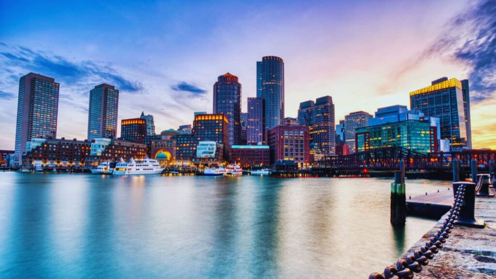A stunning sunset over the Boston skyline, showcasing a blend of warm colors and the city's distinctive architecture.