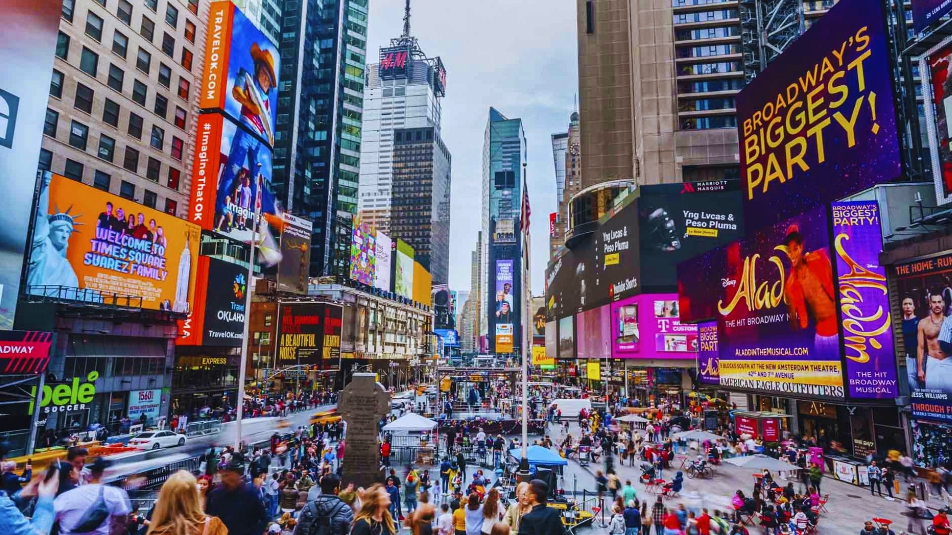 A vibrant city street teeming with pedestrians, showcasing the energy of urban life.