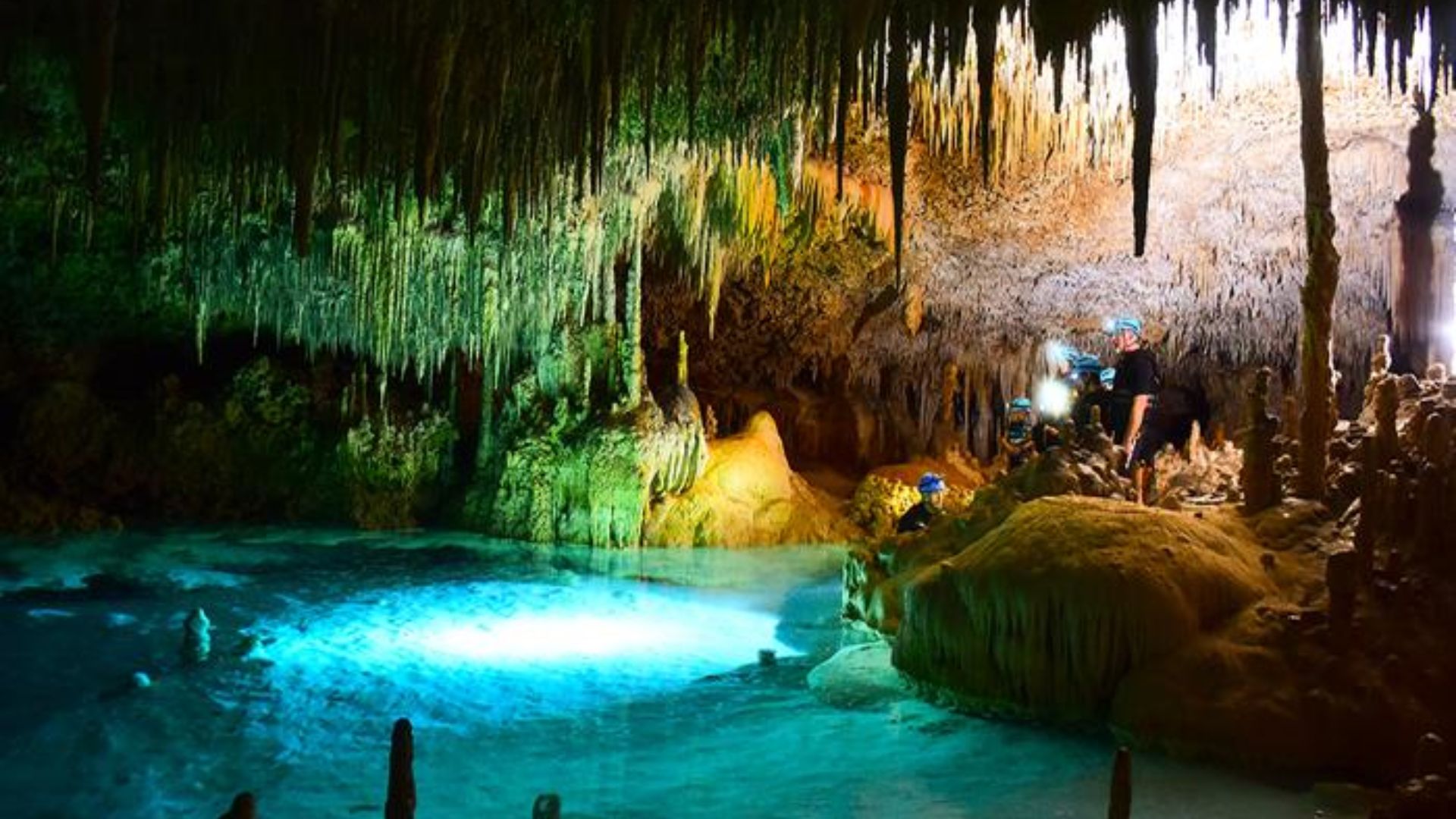 A cave illuminated by vibrant blue water, creating a serene and enchanting atmosphere.