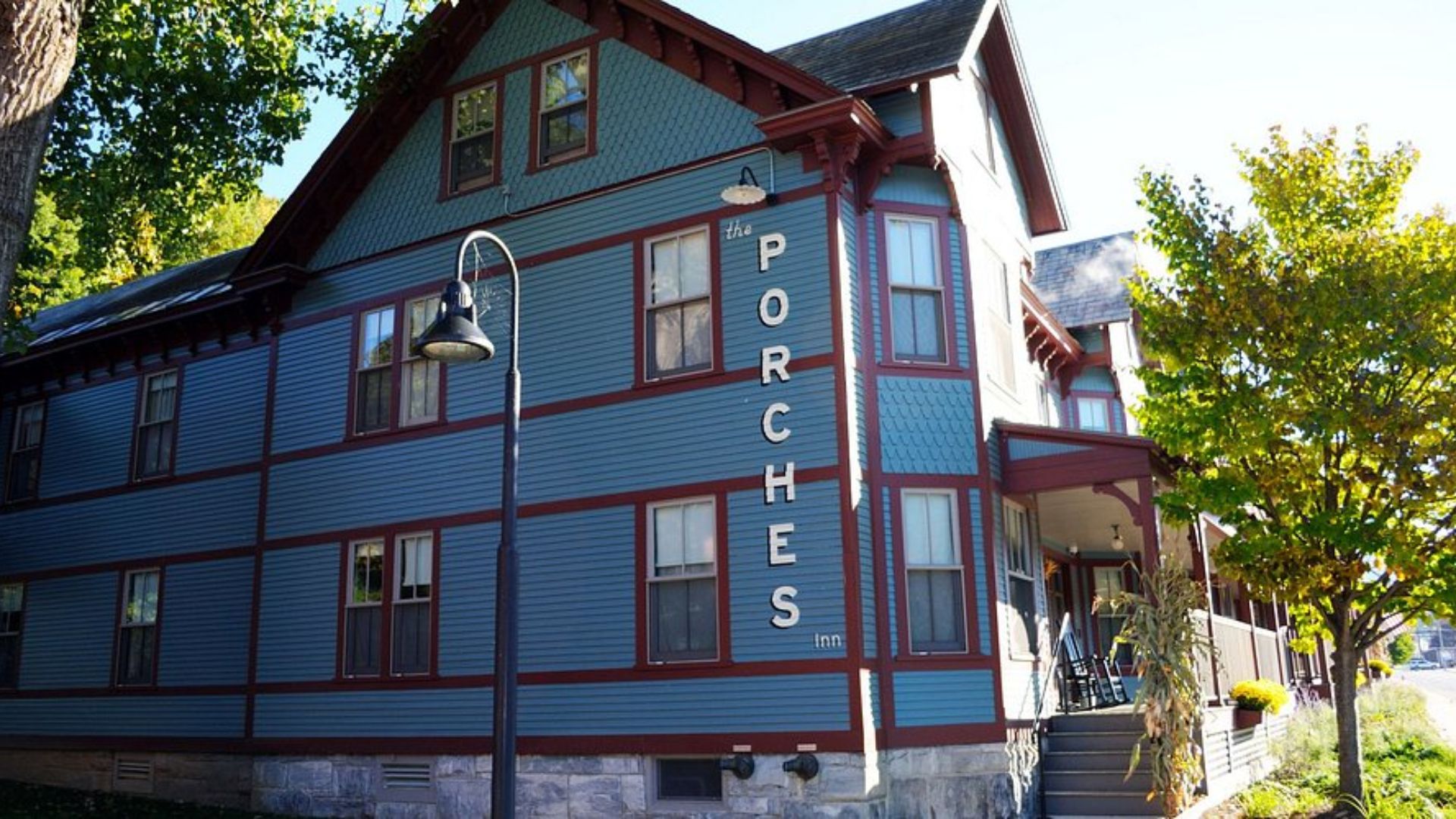 A cozy porch at the Porch Inn, featuring comfortable seating and potted plants, inviting relaxation and conversation.