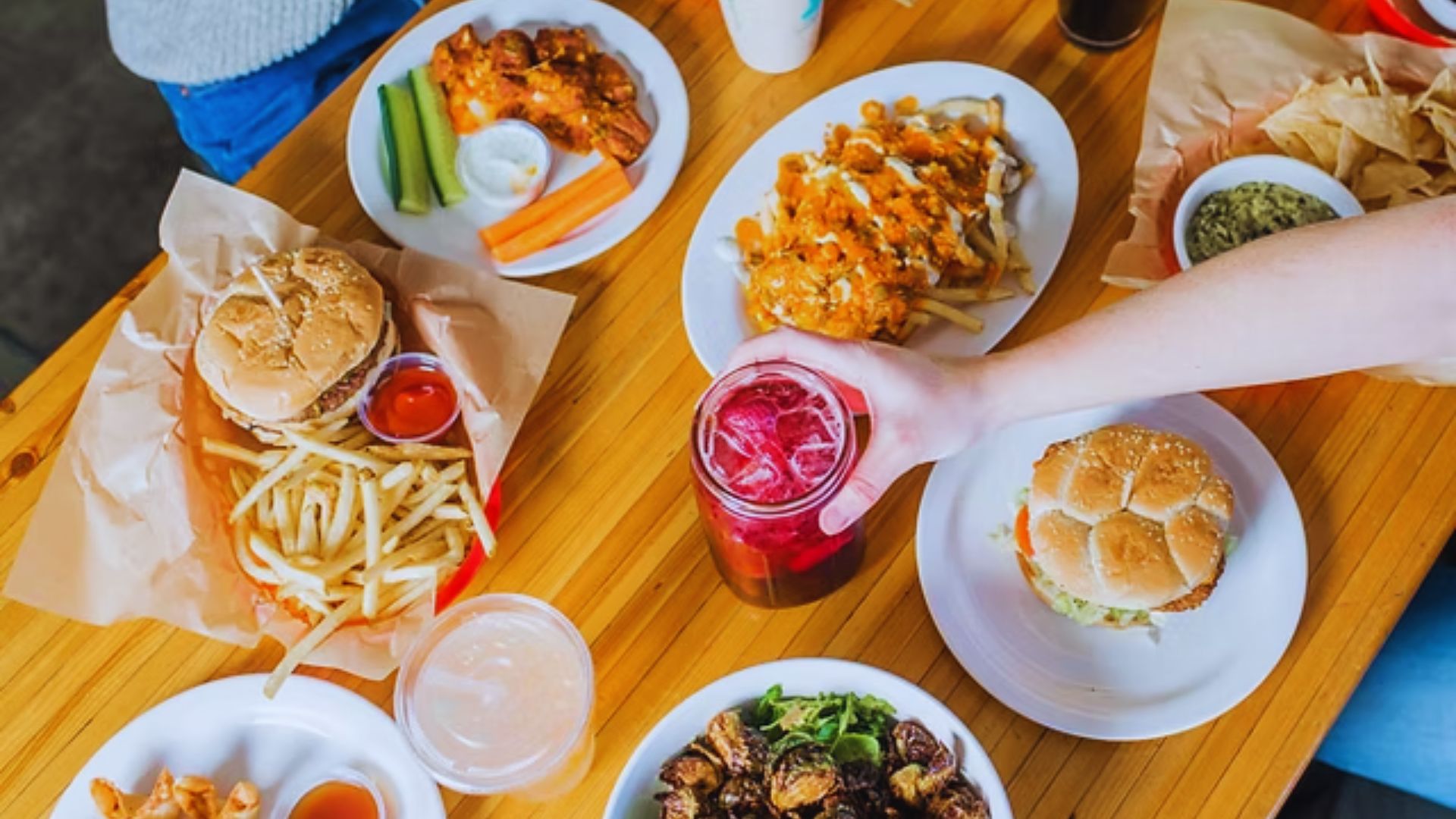 A table set with various plates of food and drinks, showcasing a colorful and appetizing spread for a meal.