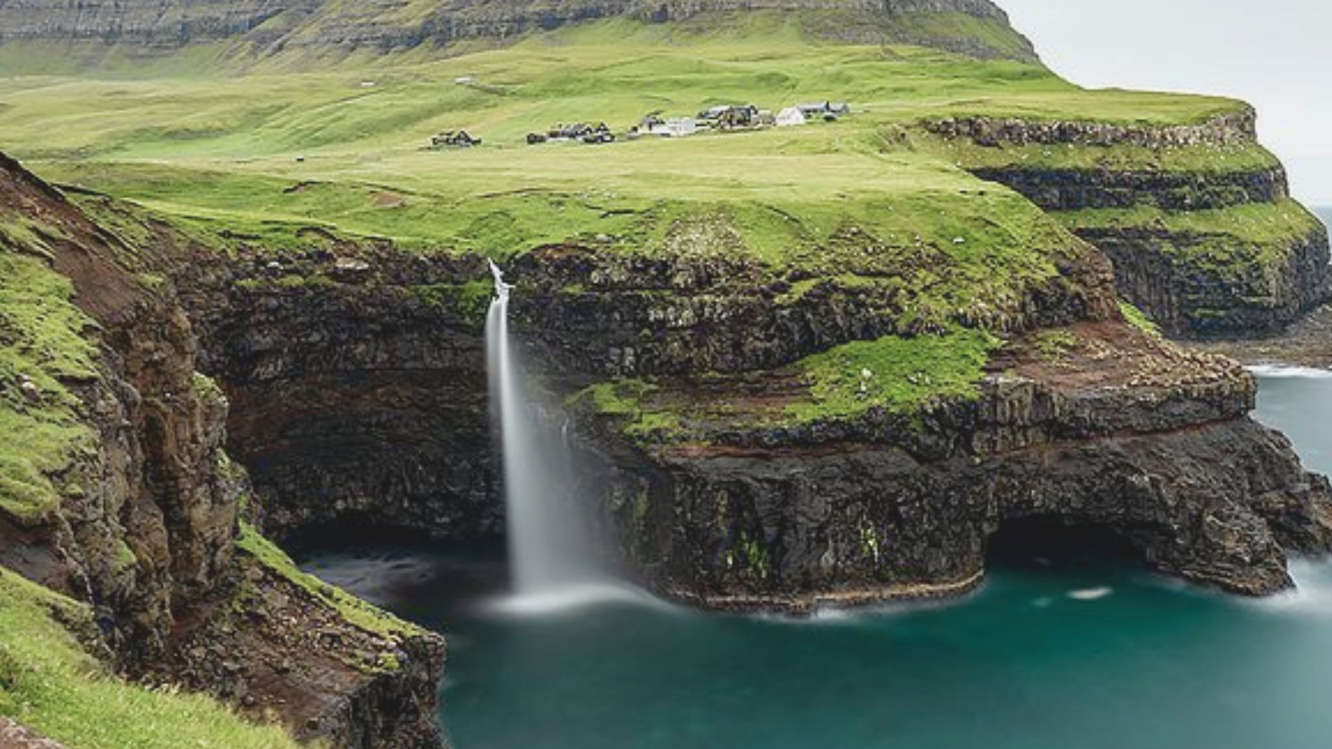 Visit Mulafossur Waterfall in Gasadalur
