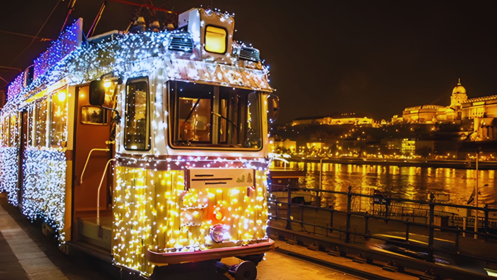 A tram adorned with colorful Christmas lights, creating a festive atmosphere in an urban setting.