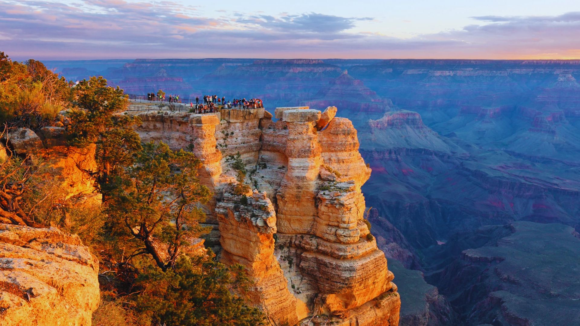 A panoramic view of the Grand Canyon, showcasing its vastness and popularity among tourists.