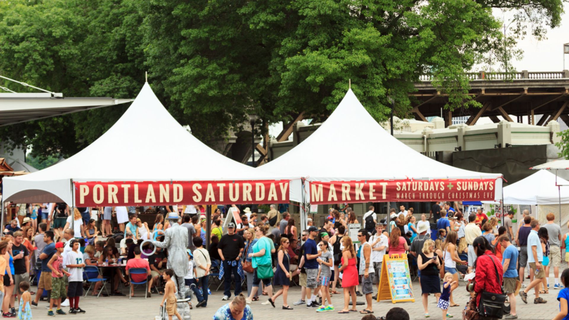 Vibrant scene of Portland Saturday Market, featuring local vendors, colorful stalls, and visitors enjoying the lively atmosphere.