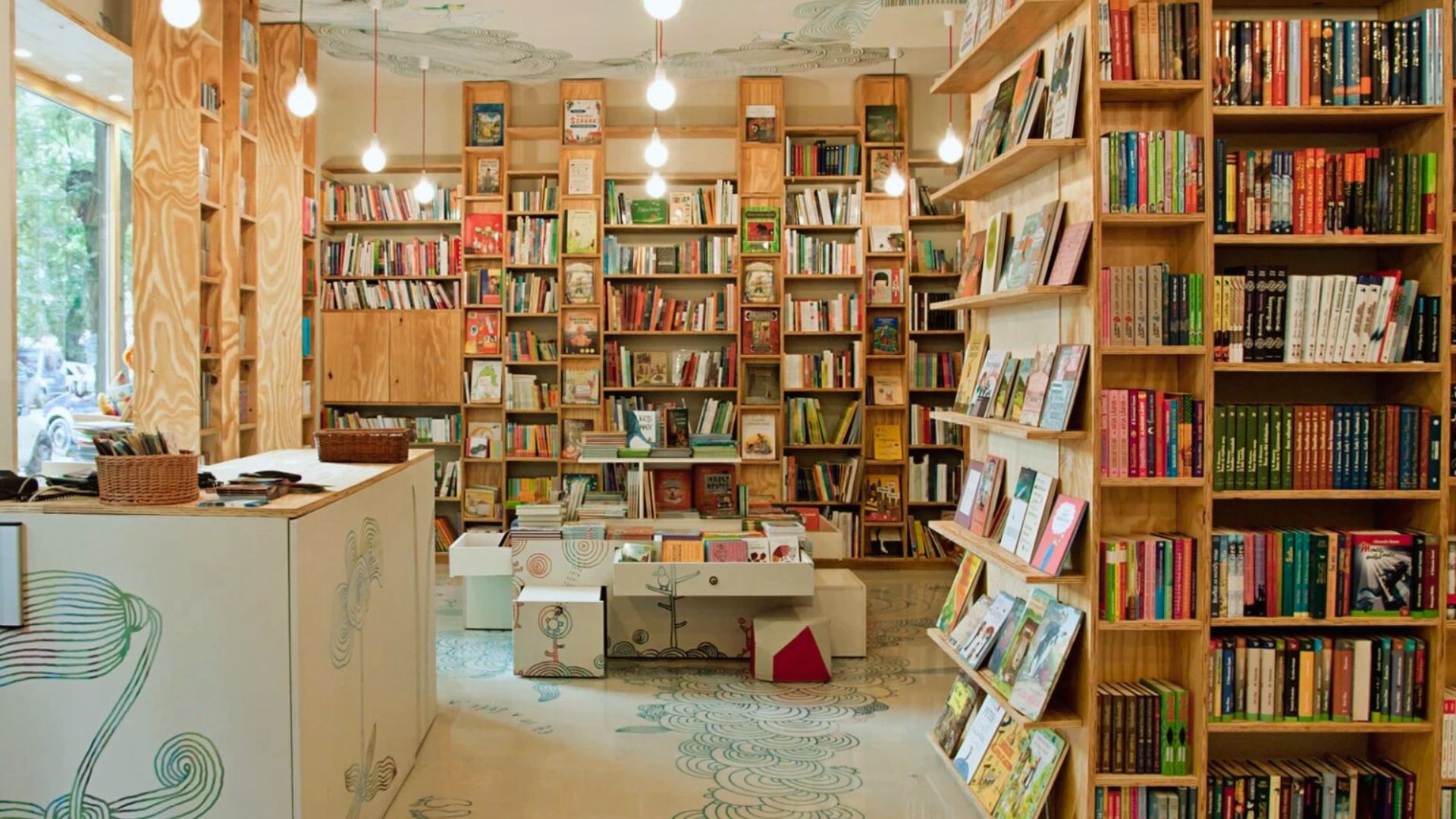A cozy bookstore filled with numerous books neatly arranged on wooden shelves.