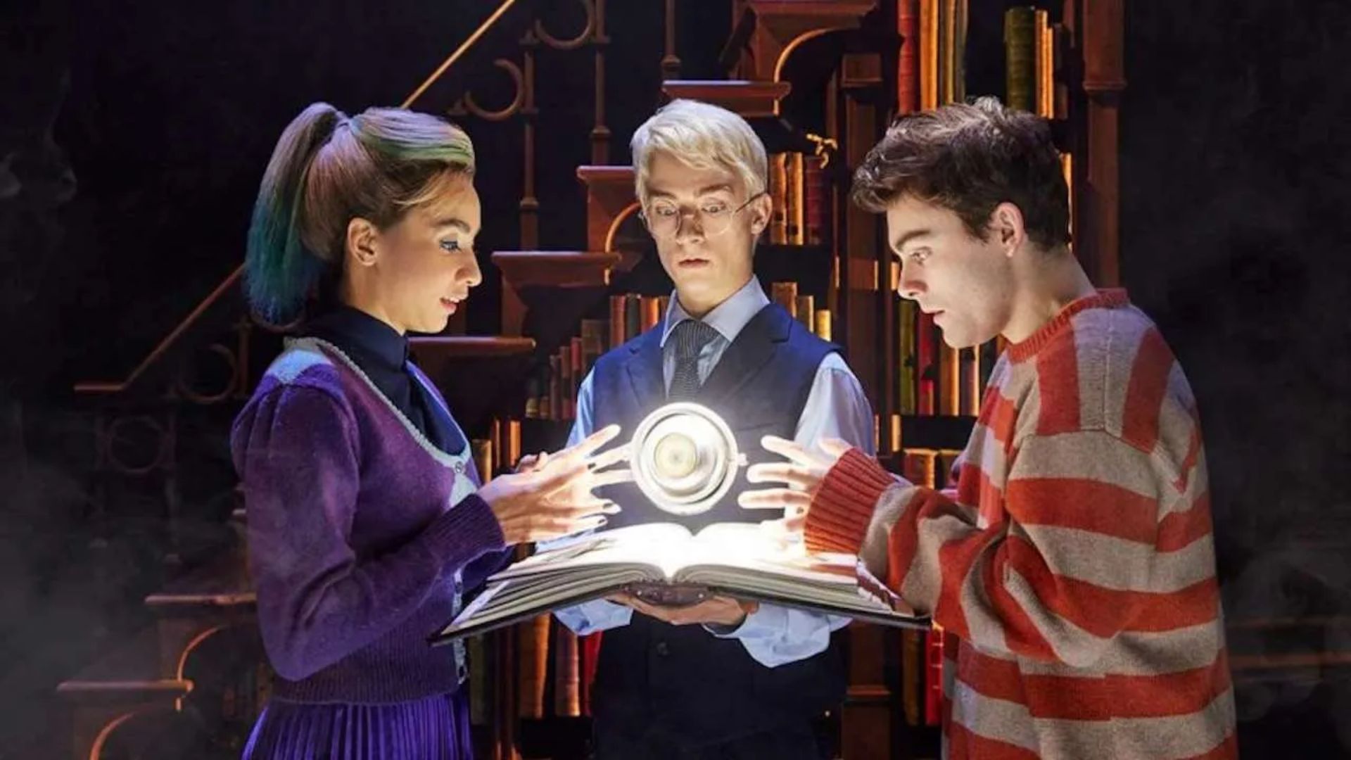 Three people gaze at a book emitting a magical light, captivated by its enchanting glow and mysterious content.