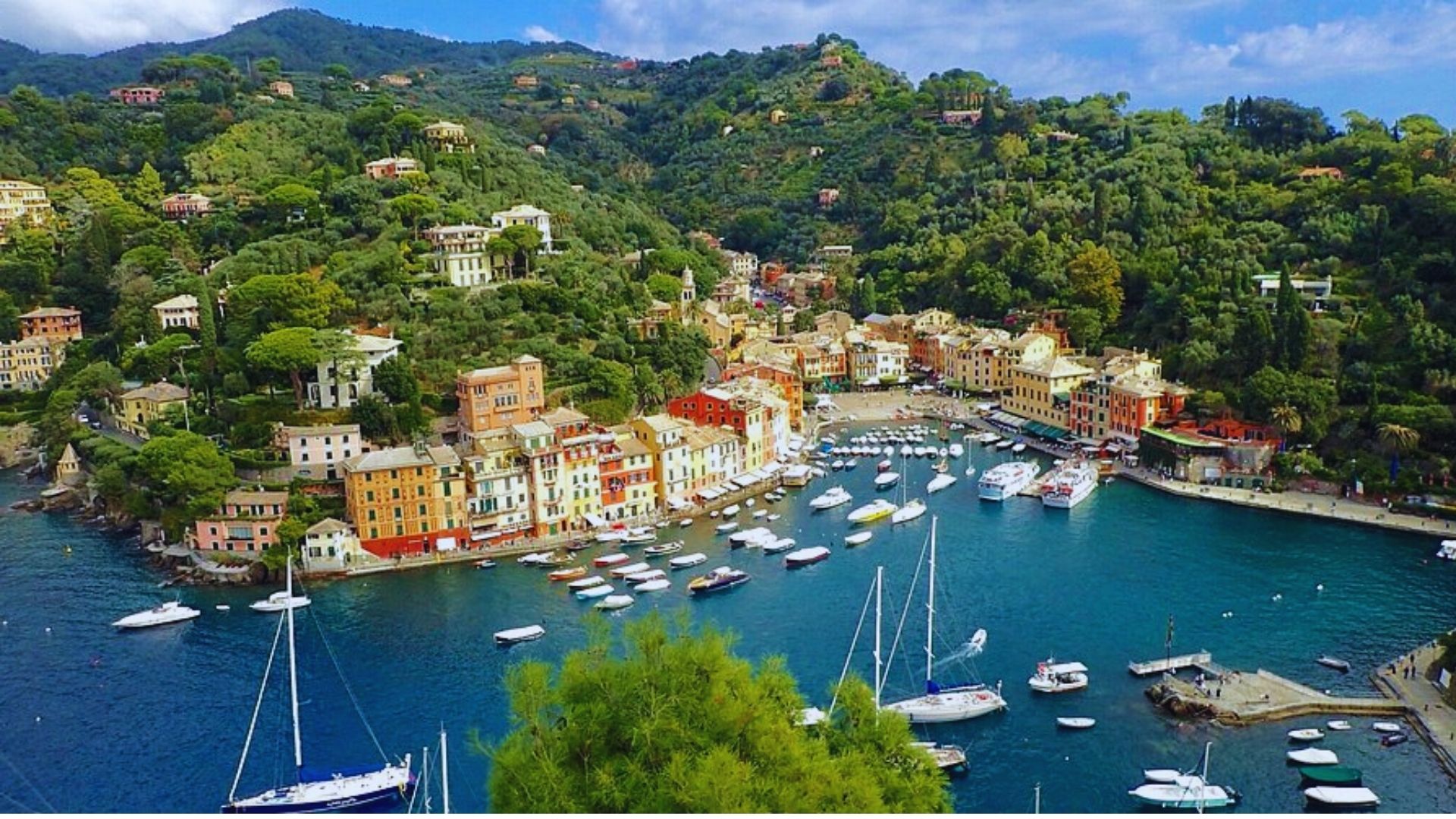 A picturesque harbor featuring boats and charming houses lining the water's edge.