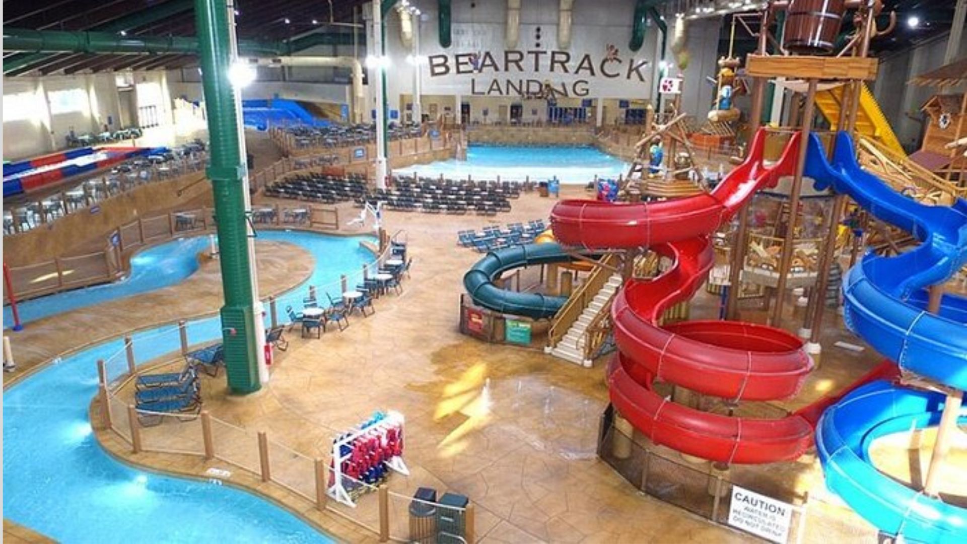 A spacious indoor water park featuring multiple water slides and attractions for visitors of all ages.