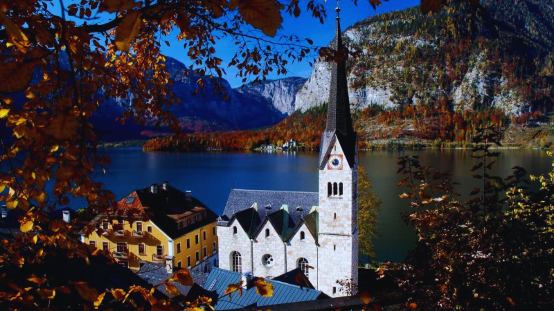 Aerial view of Hallstatt, Austria, highlighting the charming village nestled between a lake and steep mountains.