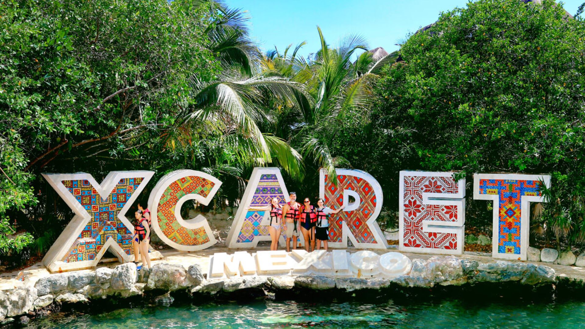 Travel guide cover for Xcaret, a popular eco-archaeological park in Mexico, showcasing vibrant attractions and activities.